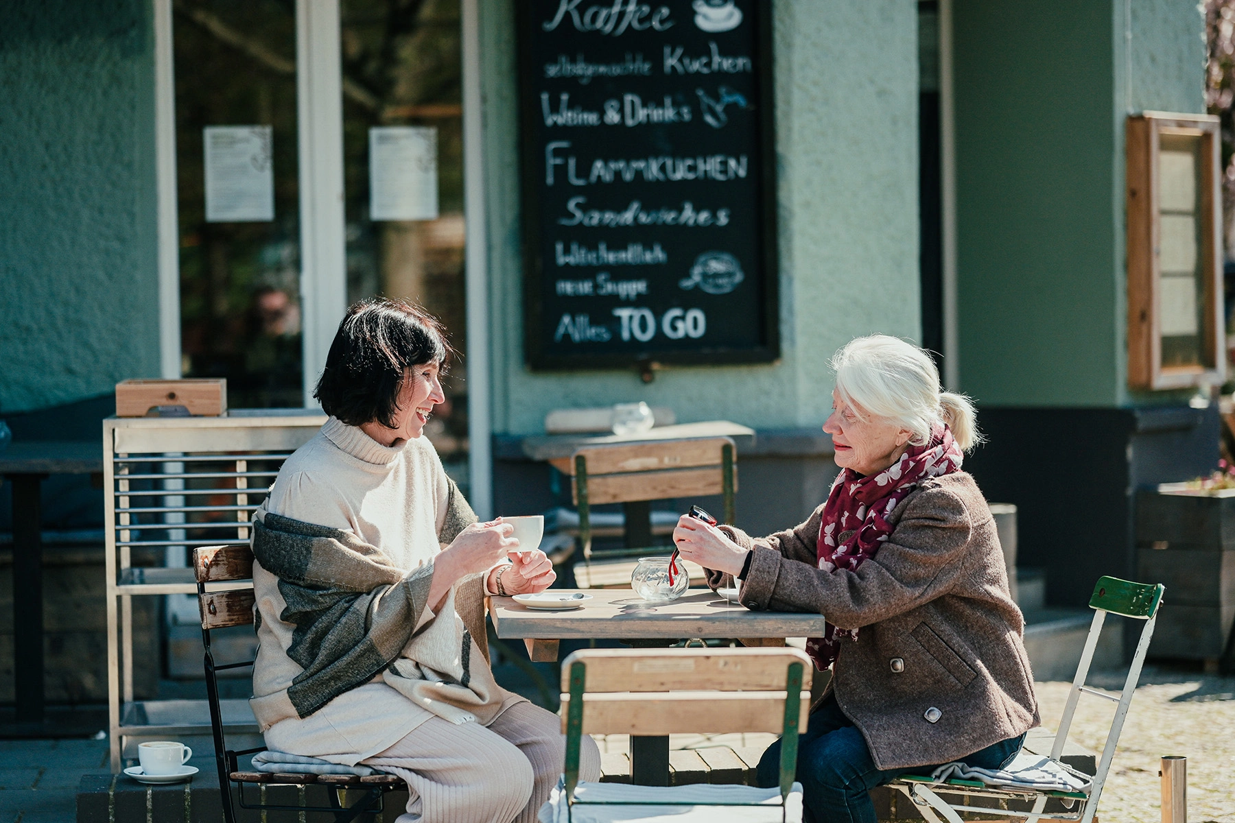 Two middle aged ladies drinking tea at a cafe in German
