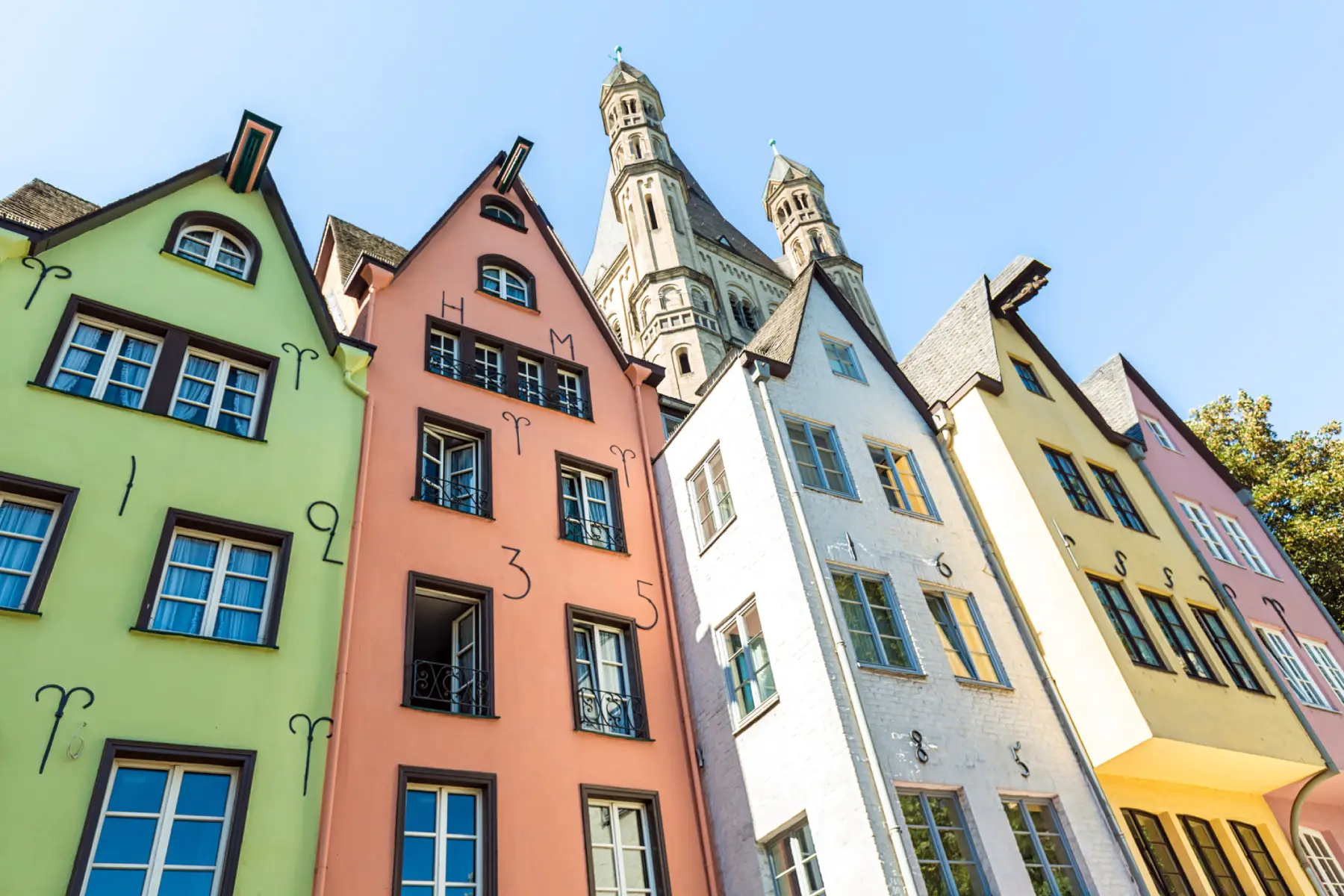 a from the ground shot of a row of colorful townhouses in Old Town Cologne 