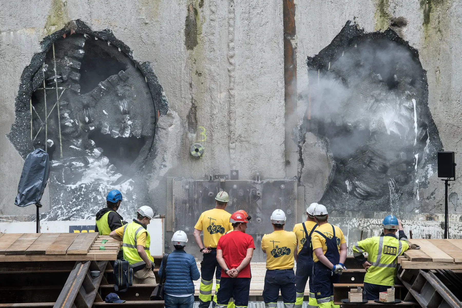 Construction workers watch tunnel drilling machines in Oberhausen