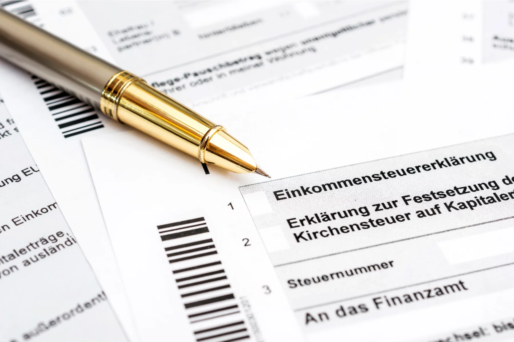 Pen resting on top of German freelance tax forms