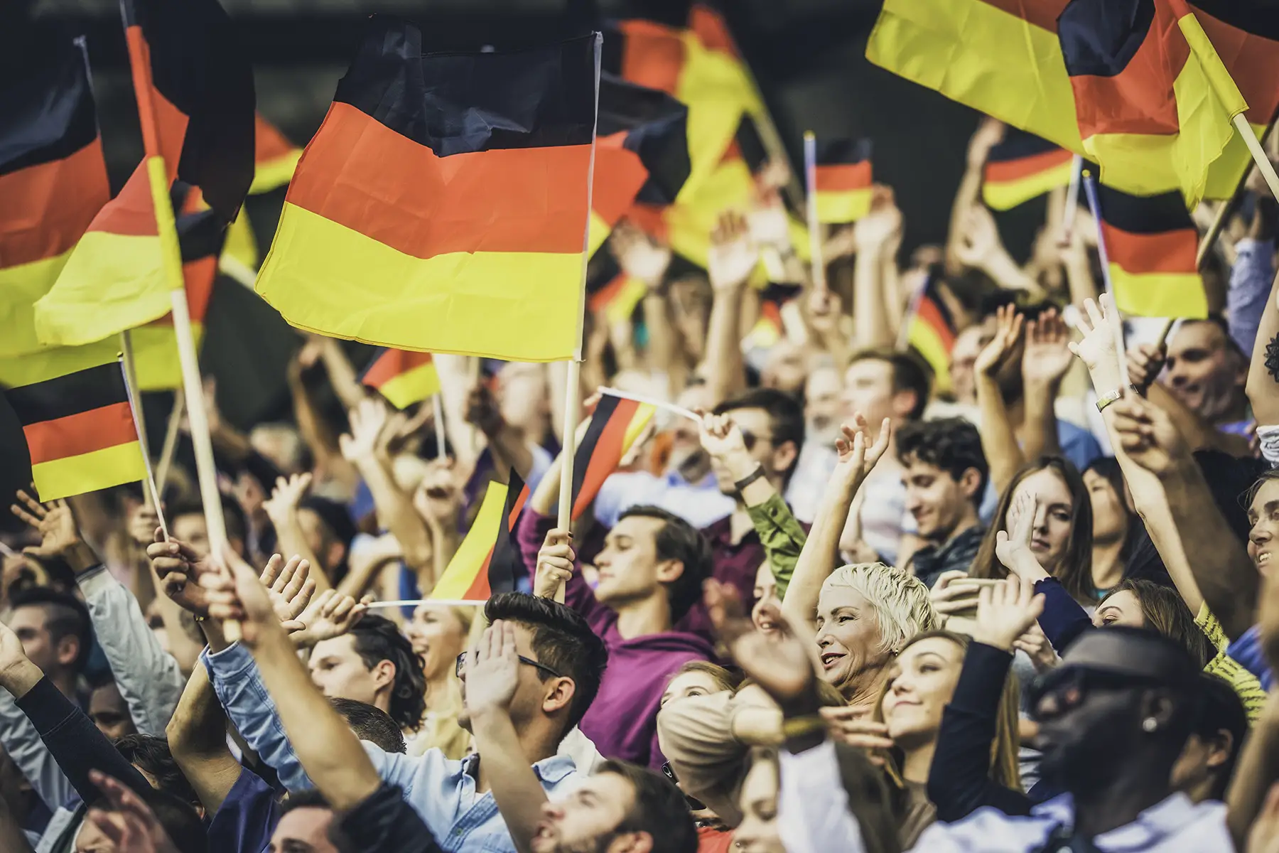 German people hold flags in a stadium