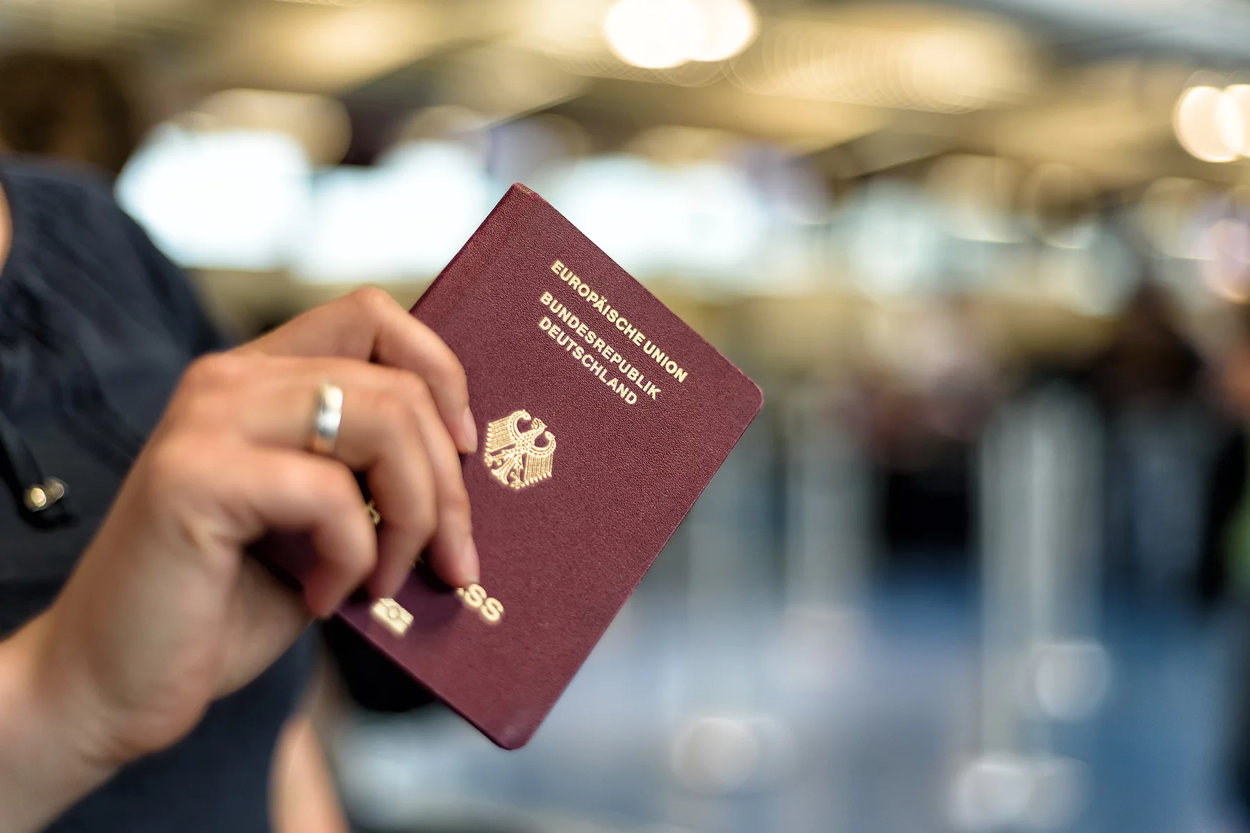 Close-up of a hand holding a German passport