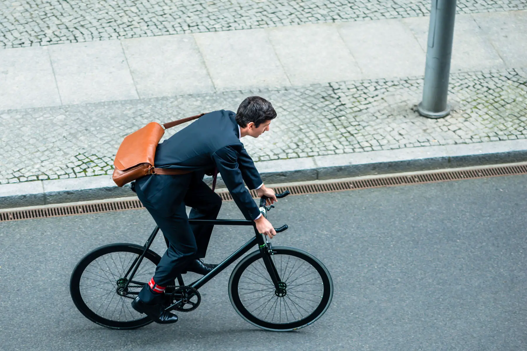 working in Germany: businessman riding a bike in Berlin