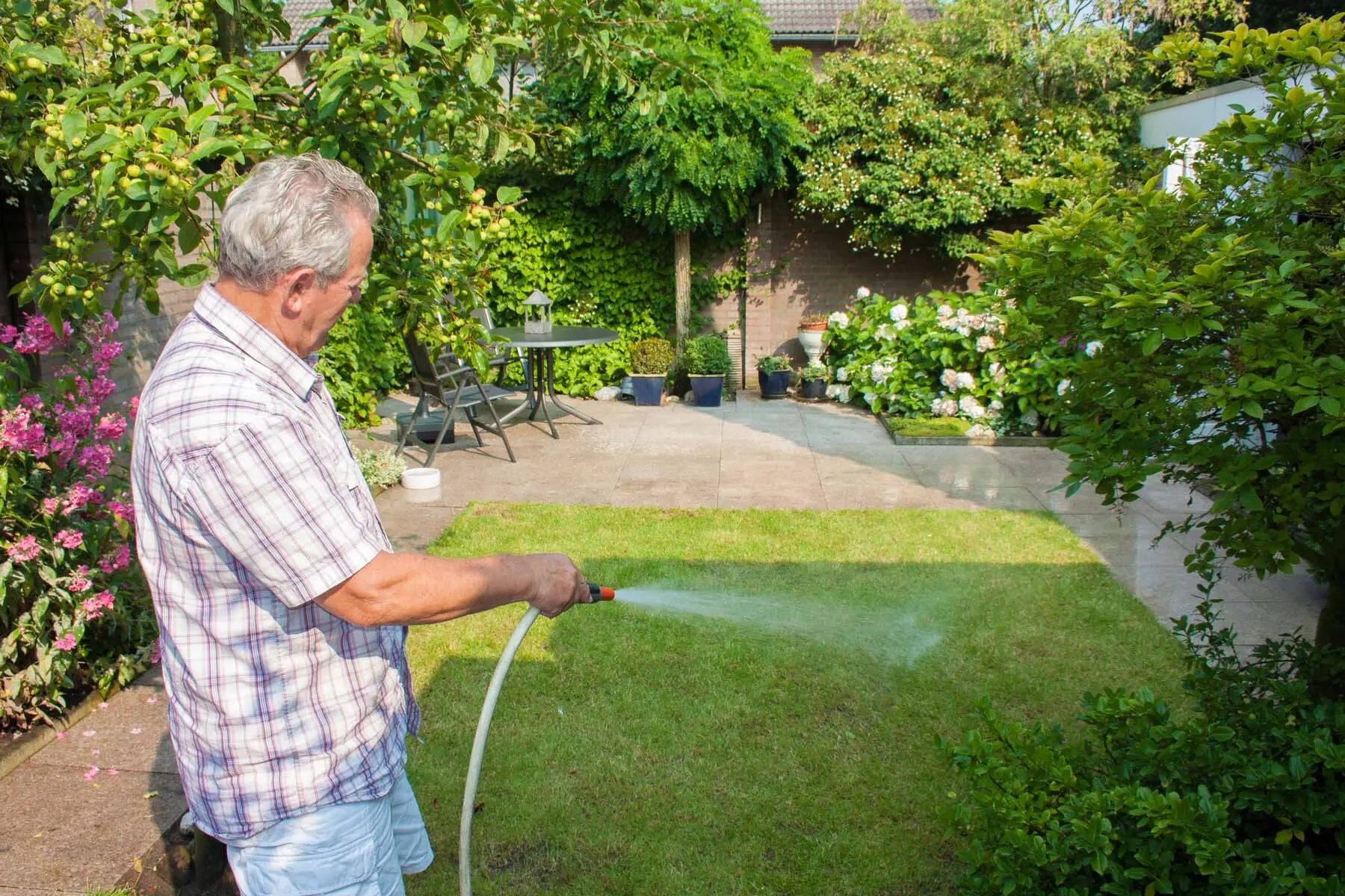 man watering garden