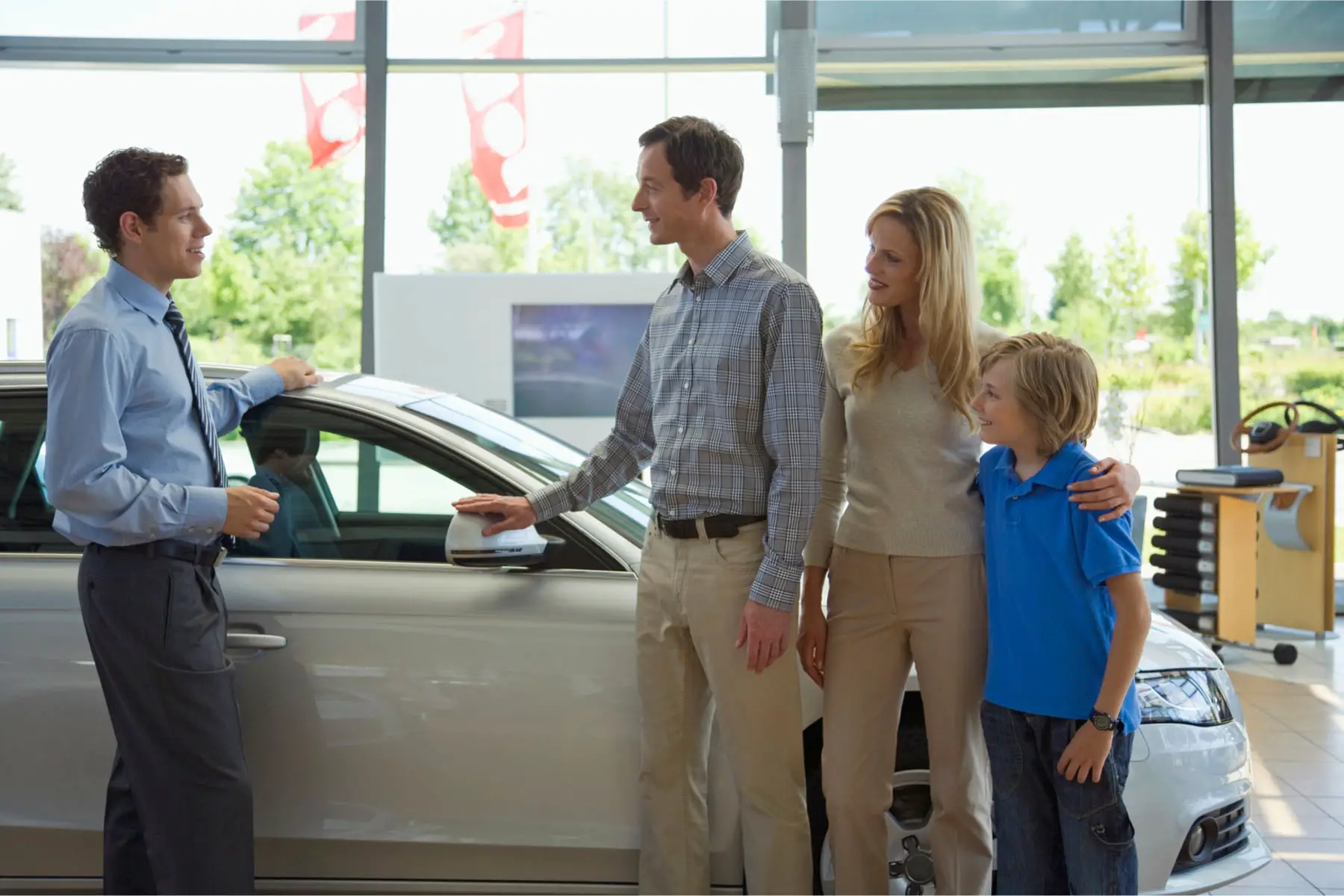 a family buying a car at a dealership