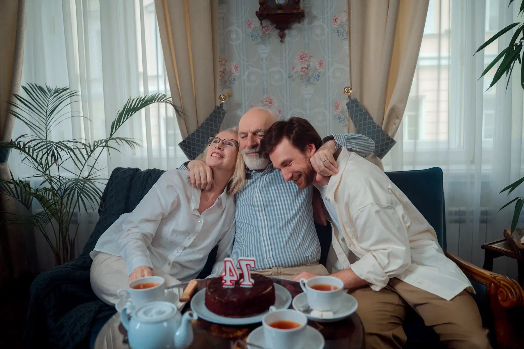 Three people having a small birthday celebration