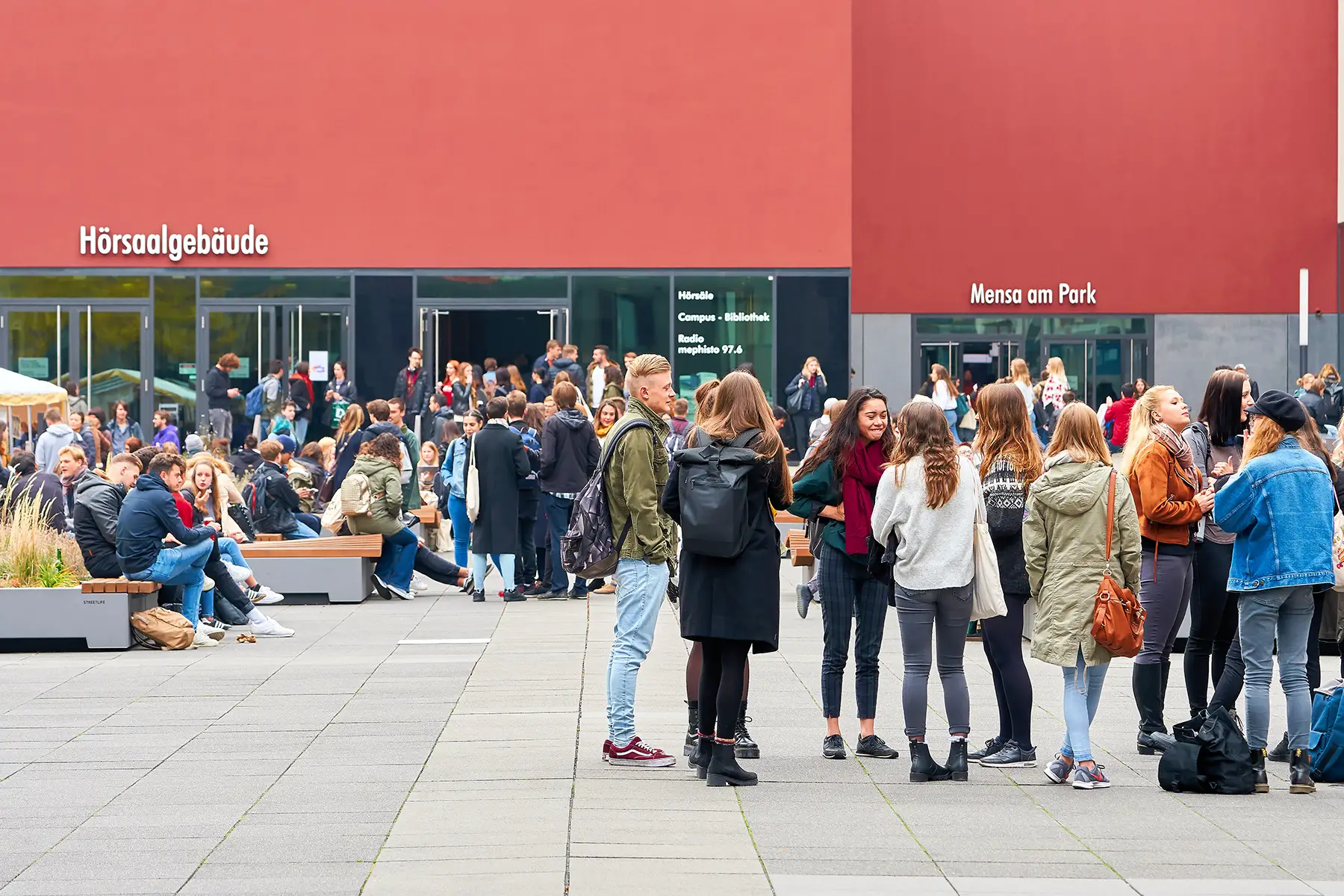 Groups of students standing outside a university campus