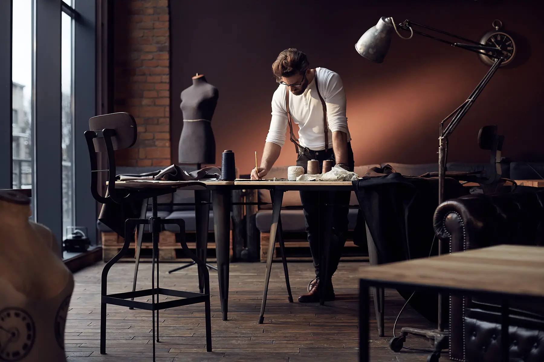 Freelance tailor in his studio