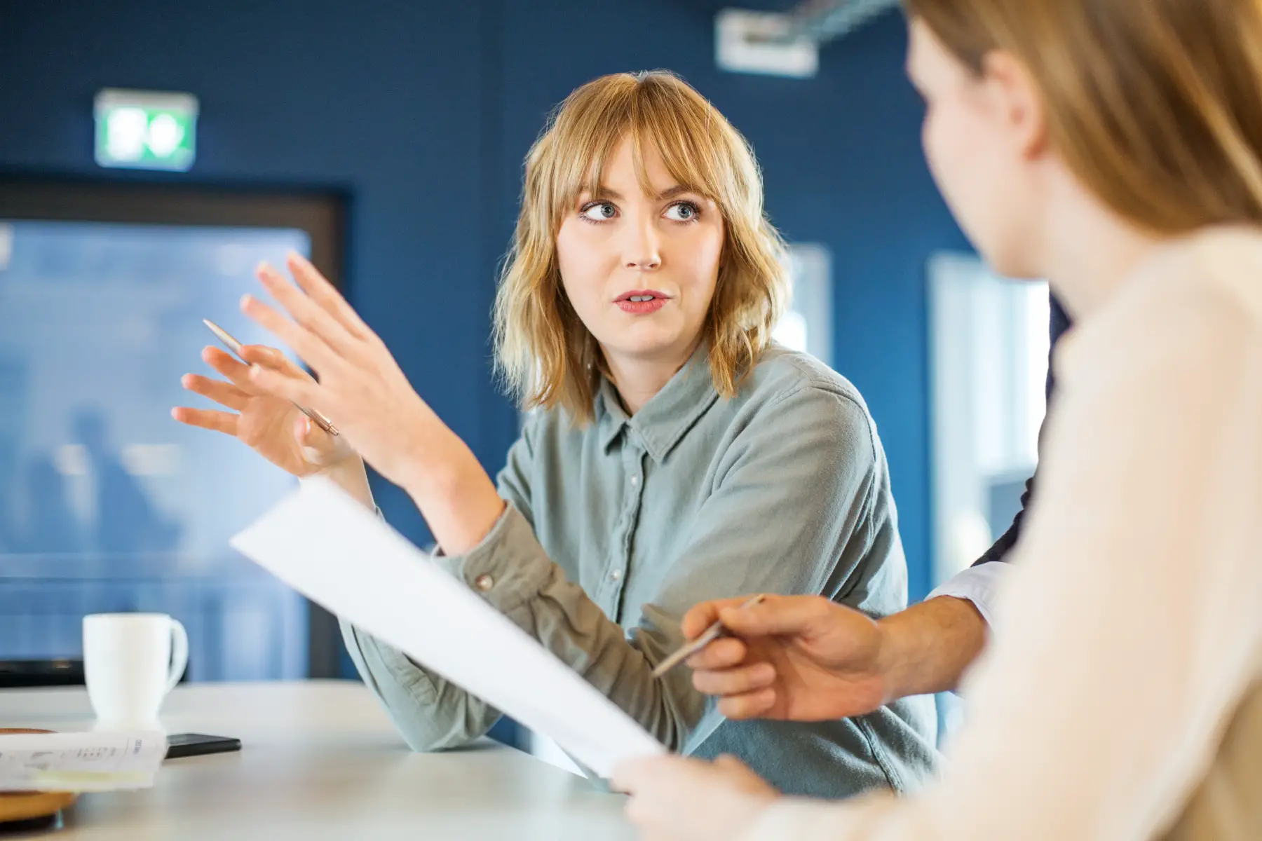 Woman discussing and using hand gestures during one-on-one meeting