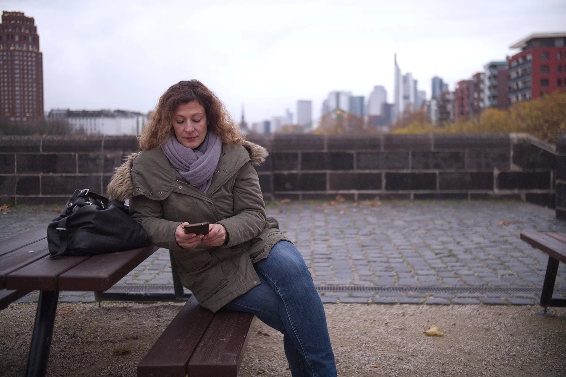 Woman using her mobile phone in Frankfurt, Germany