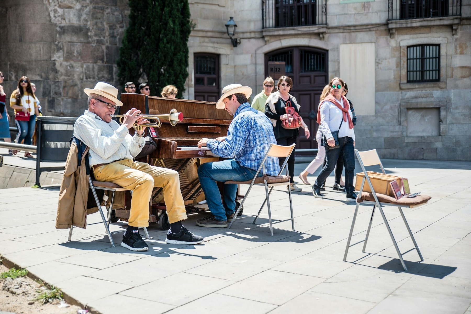 Musicians perform on the street in Spain for passing tourists
