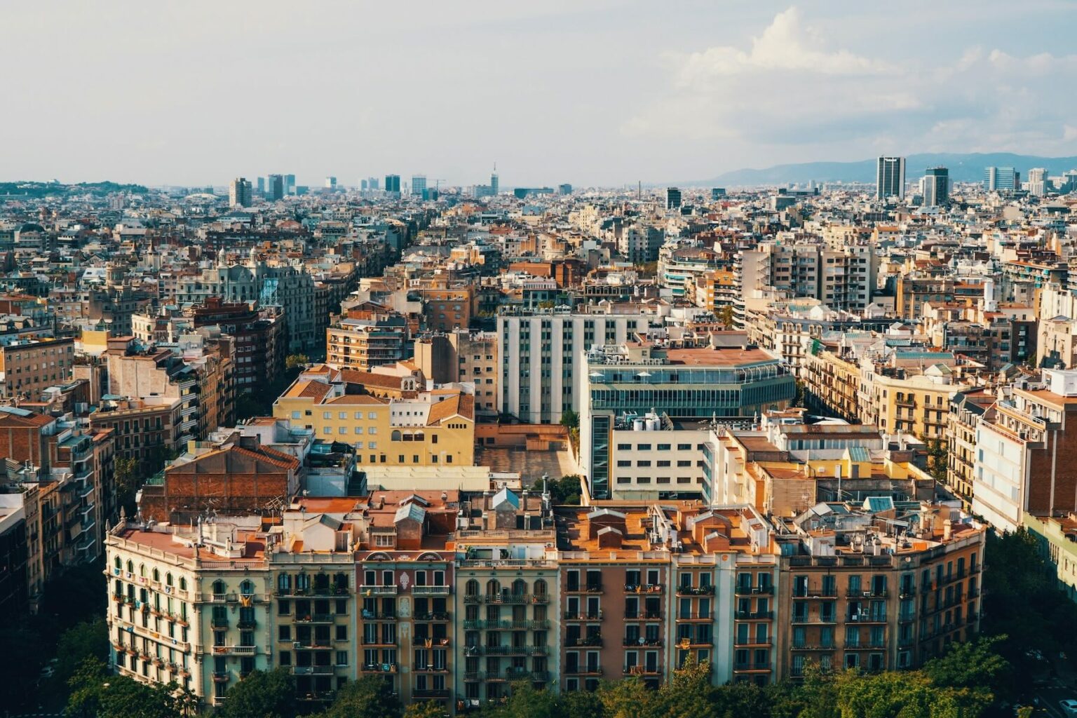 A city view of Barcelona with building rooftops shown from the sky