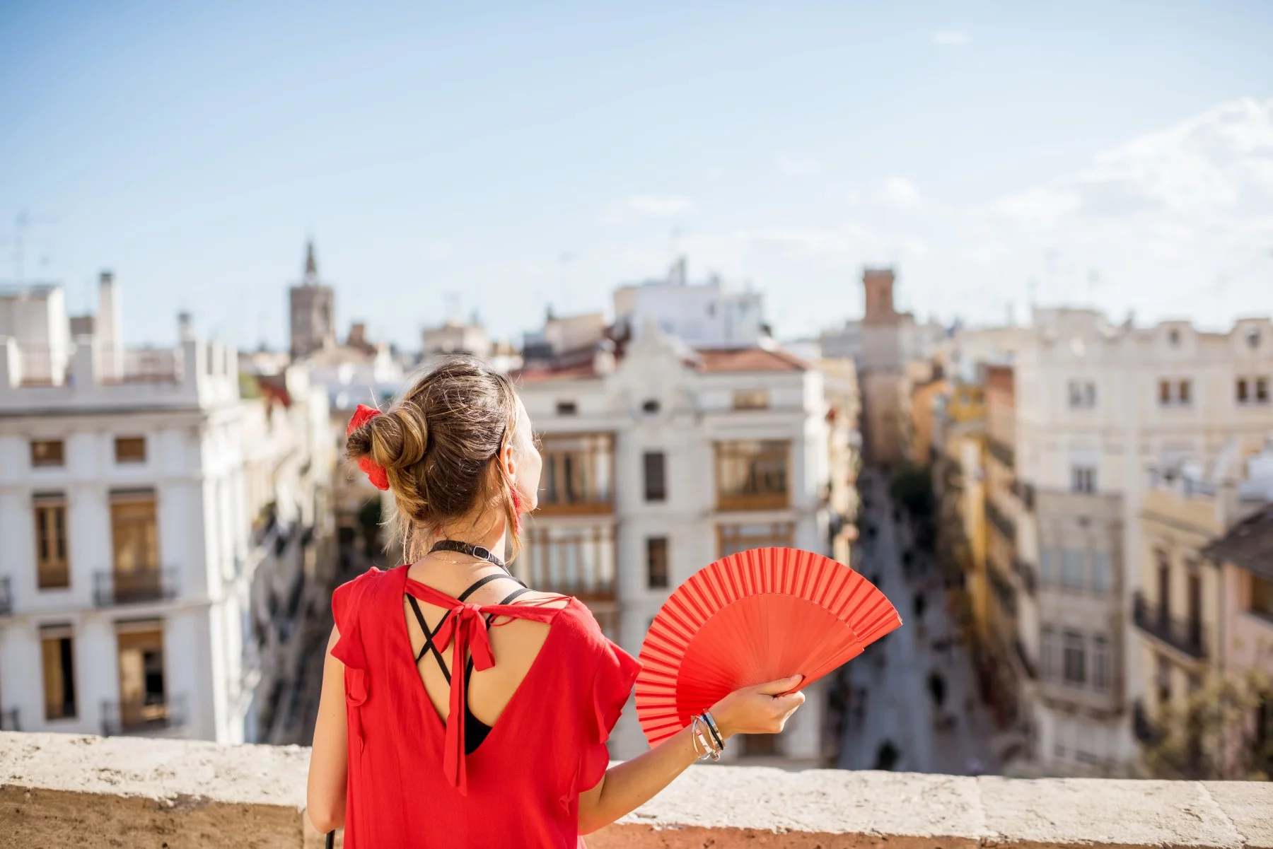 Woman on balcony in Valencia, warm weather in Spain