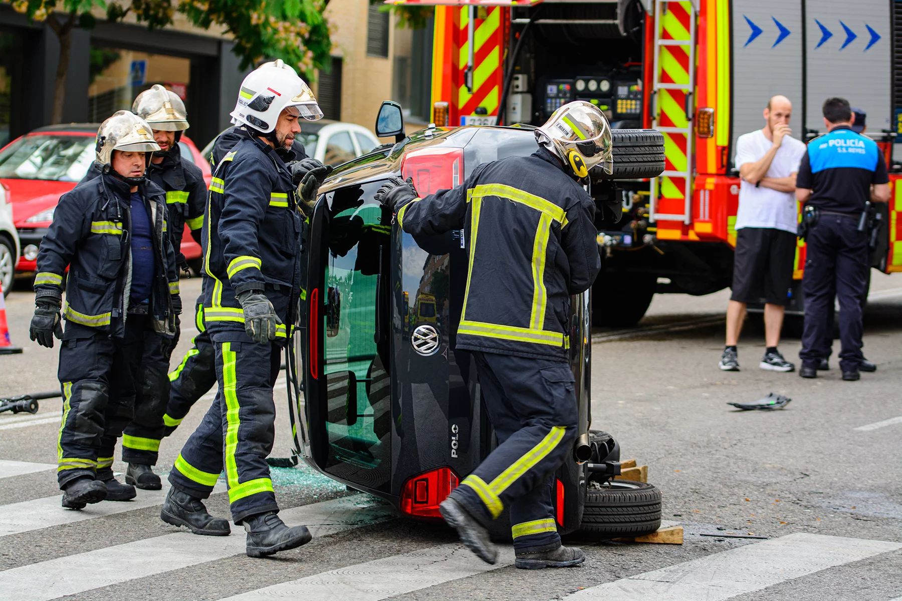 Firefighters at the scene of a car crash in Madrid, Spain
