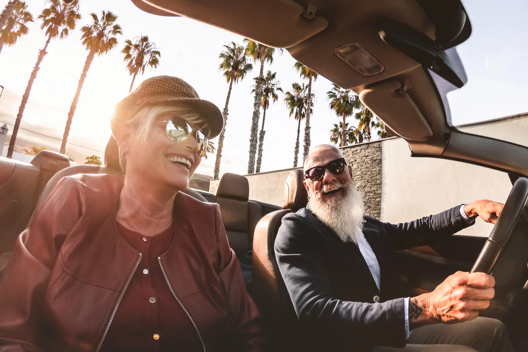Elderly couple driving a convertible