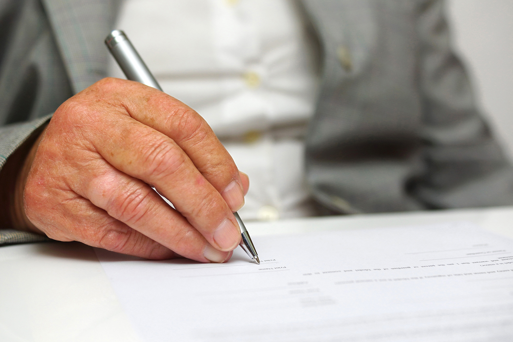 Elderly woman signing her will