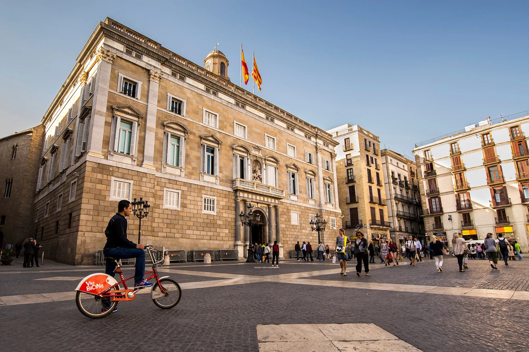 A man on a bike in Sant Jaume Square in Barcelona
