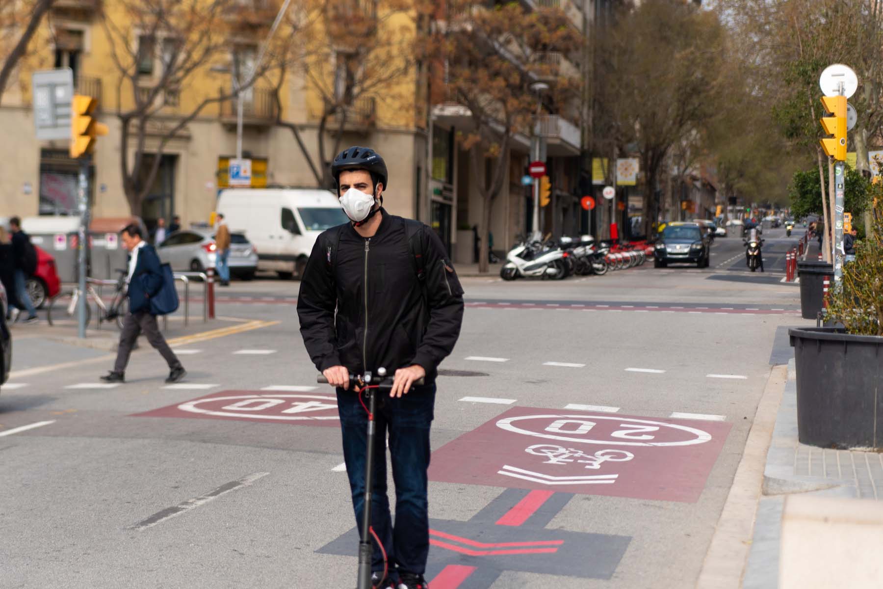 man wearing mask on scooter in Spain during Covid