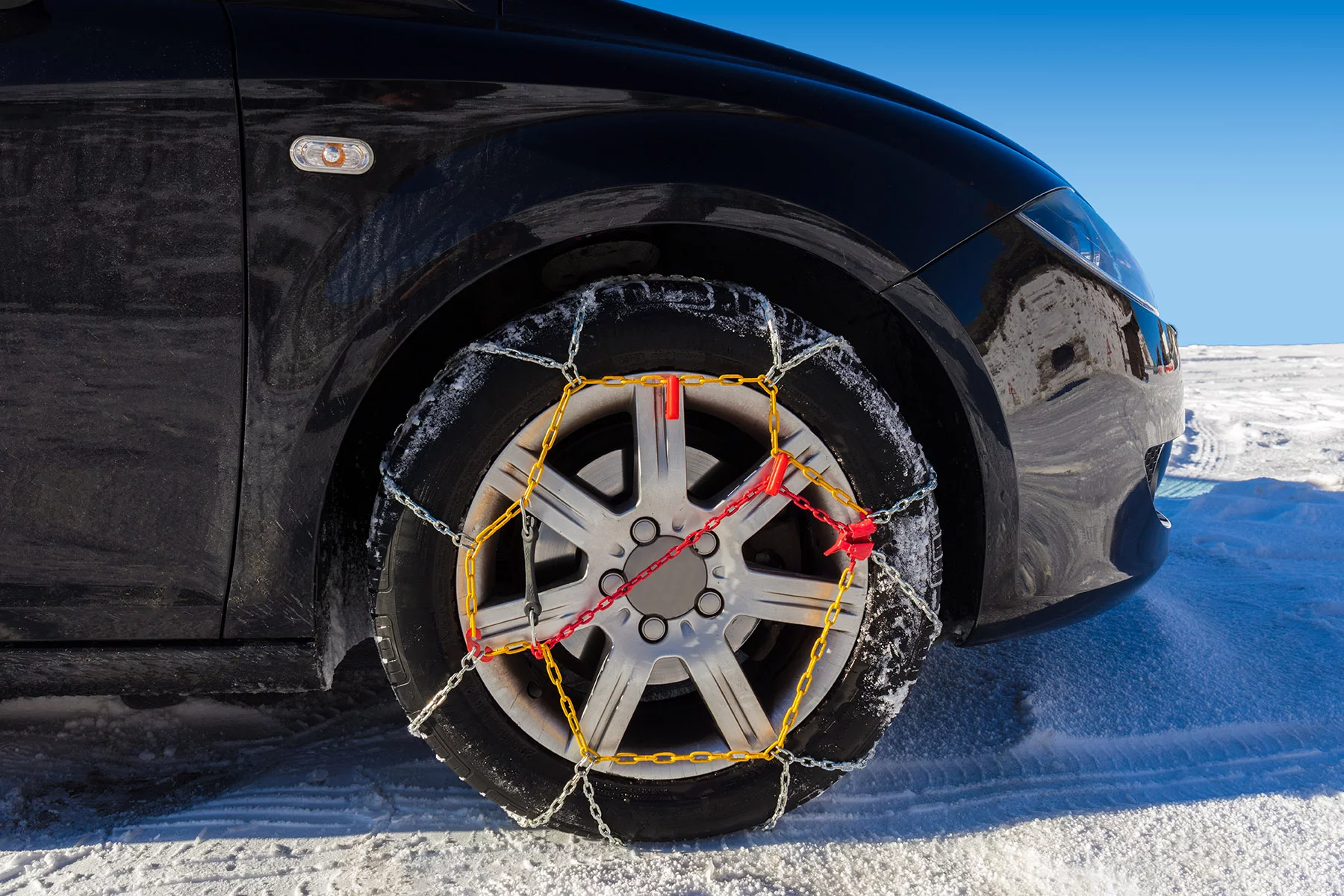 Car with snow chains in the Sierra Nevada, Spain
