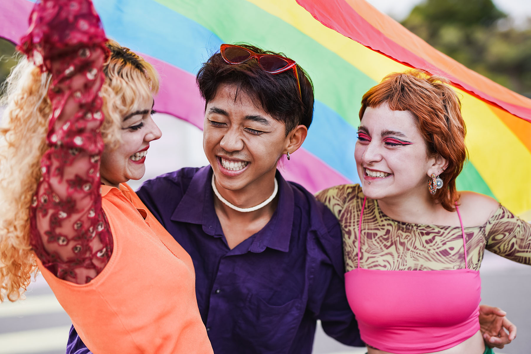 Young diverse people having fun at LGBT pride parade.