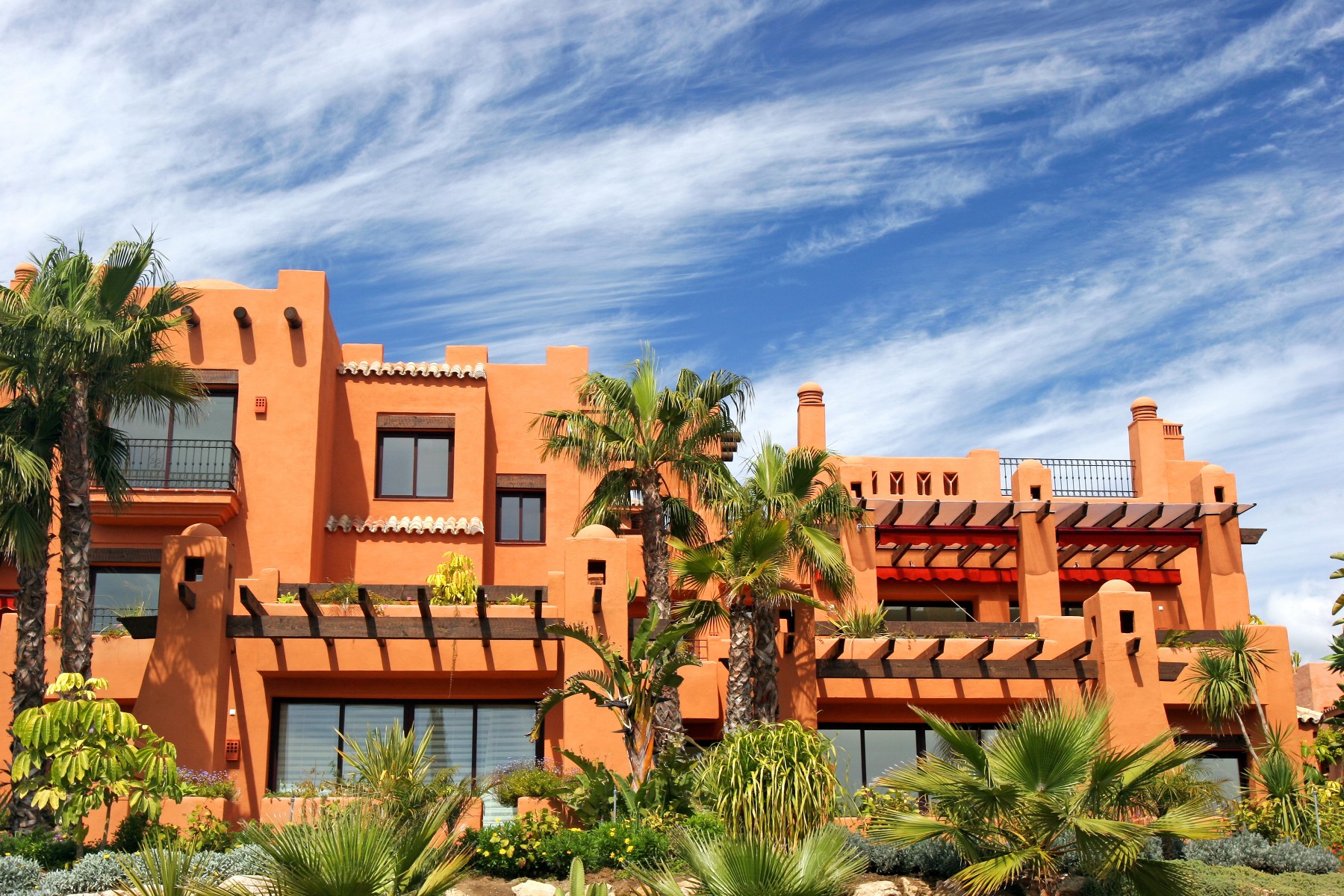Vibrant houses in Spain with palm trees in front yards