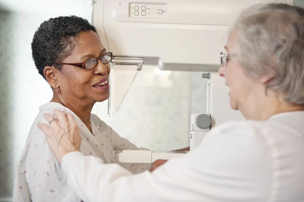 A senior woman getting a mammogram/cancer screening on her senior health insurance in Spain