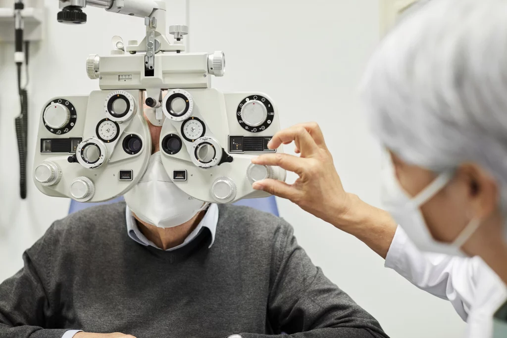 An ophthalmologist examining a senior patient's eyes - health insurance in Spain