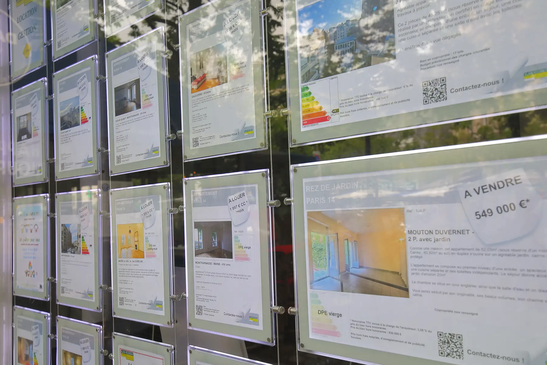 Housing adverts in an estate agent window in Paris