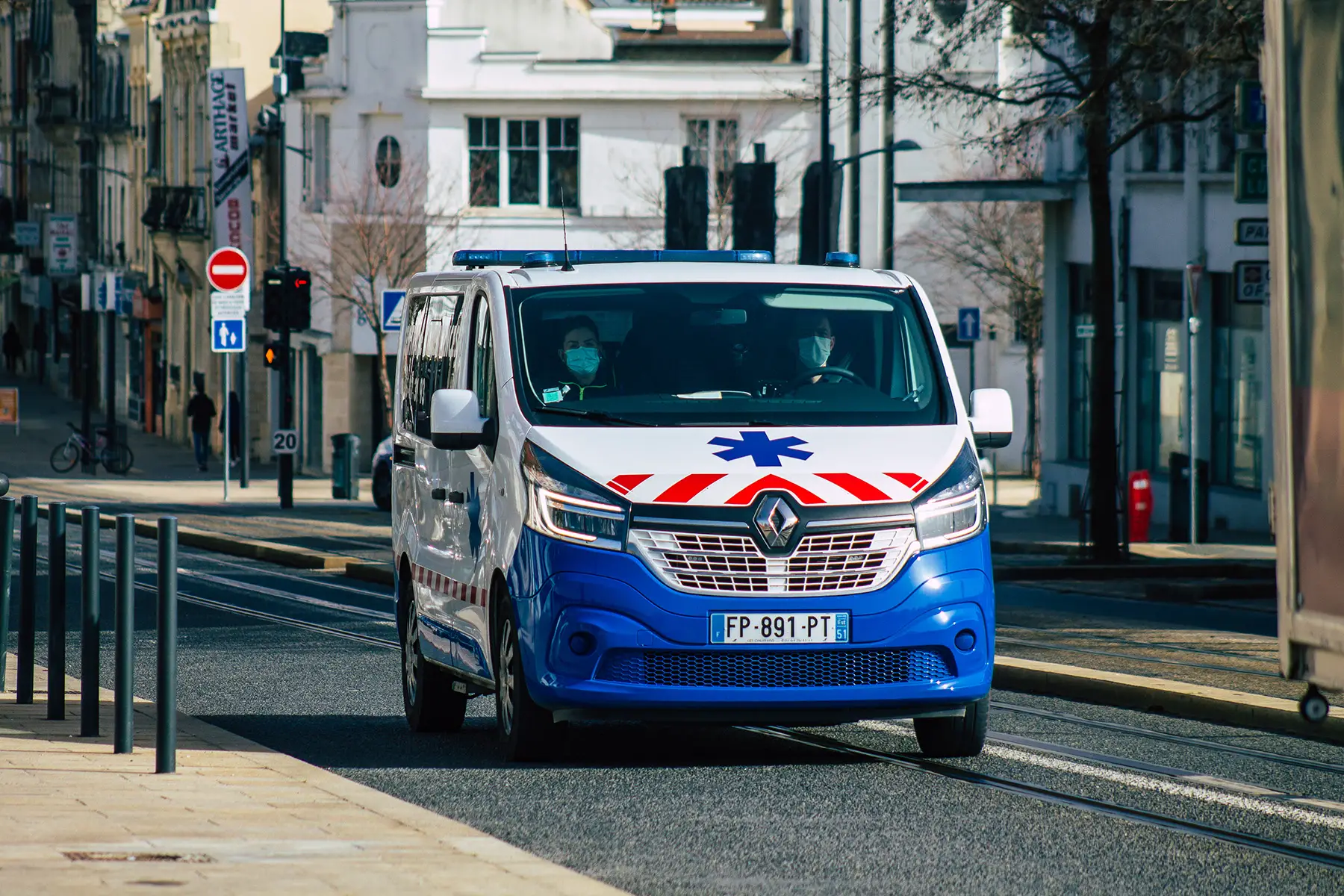 an ambulance driving through the streets of Reims