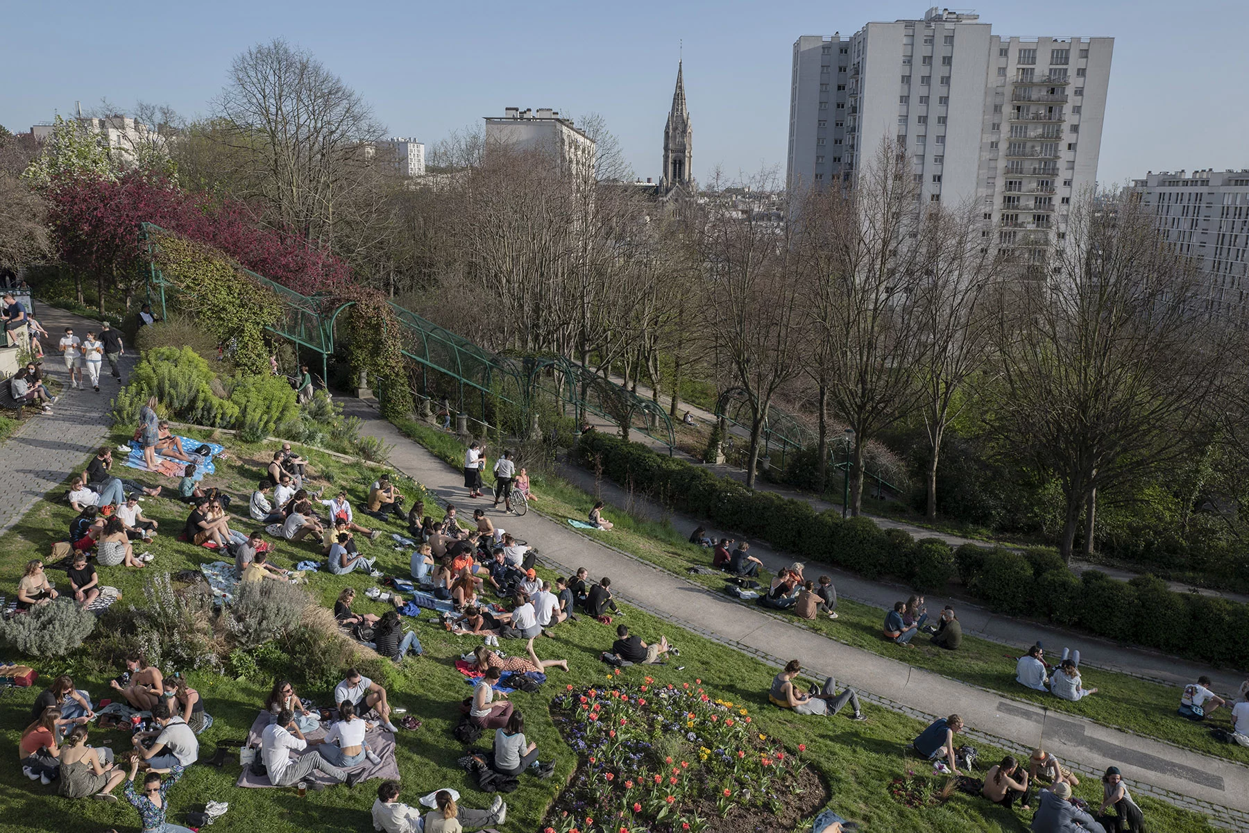 People enjoying warm weather at the Belleville park in the 20th arrondissement of Paris