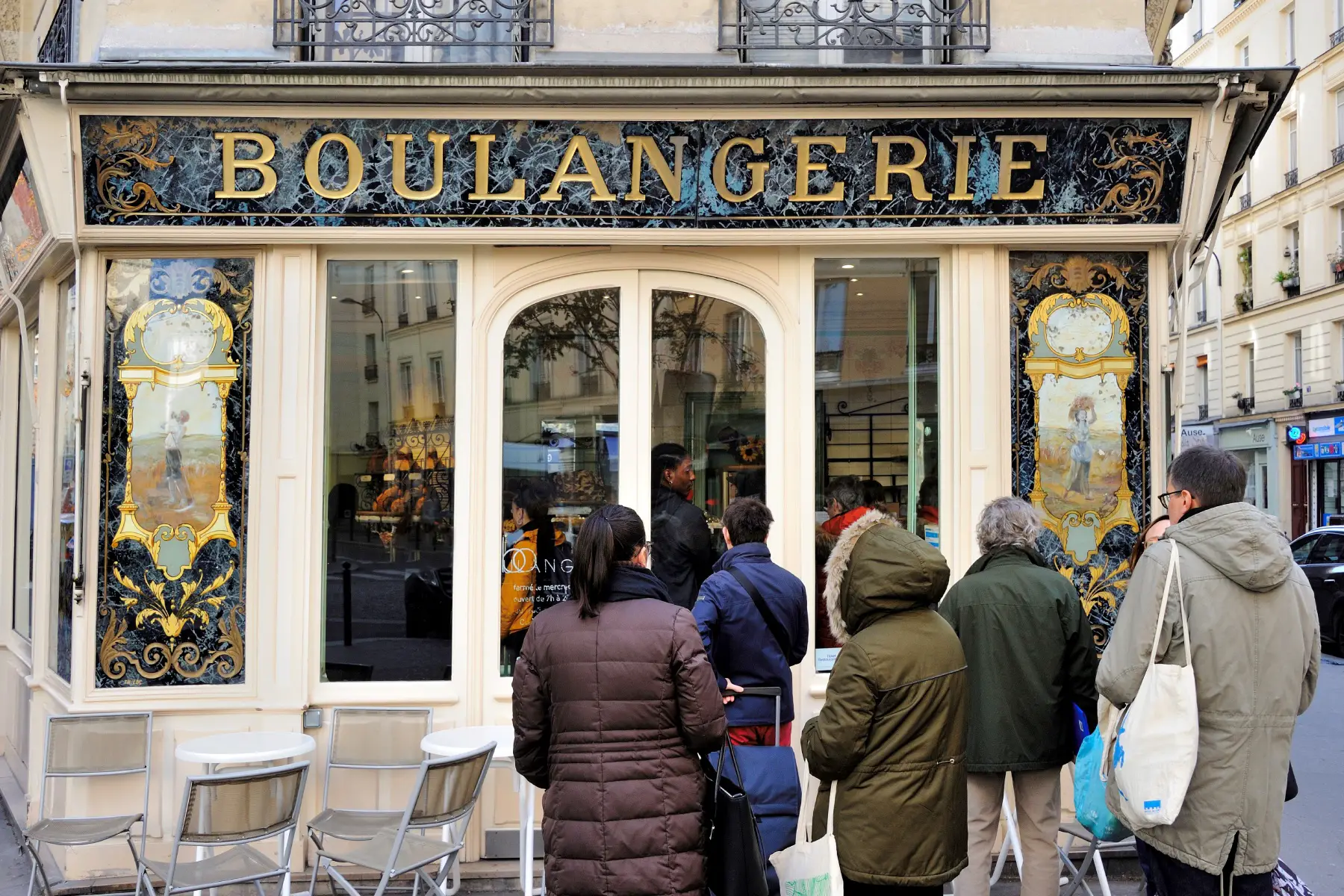 Queue forming outside of a boulangerie in Paris during winter