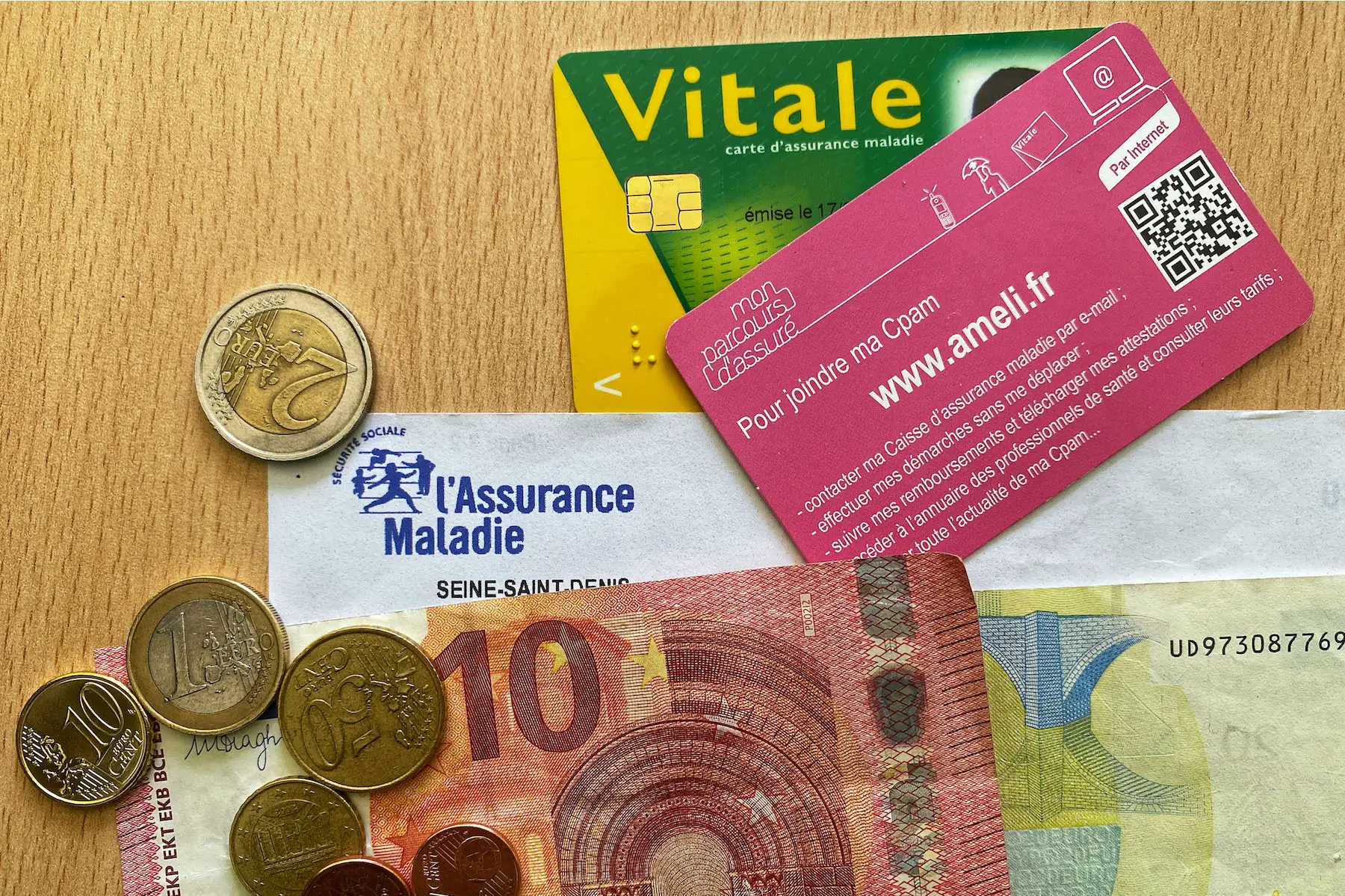 Carte vitale, French health insurance form, euro notes, and change