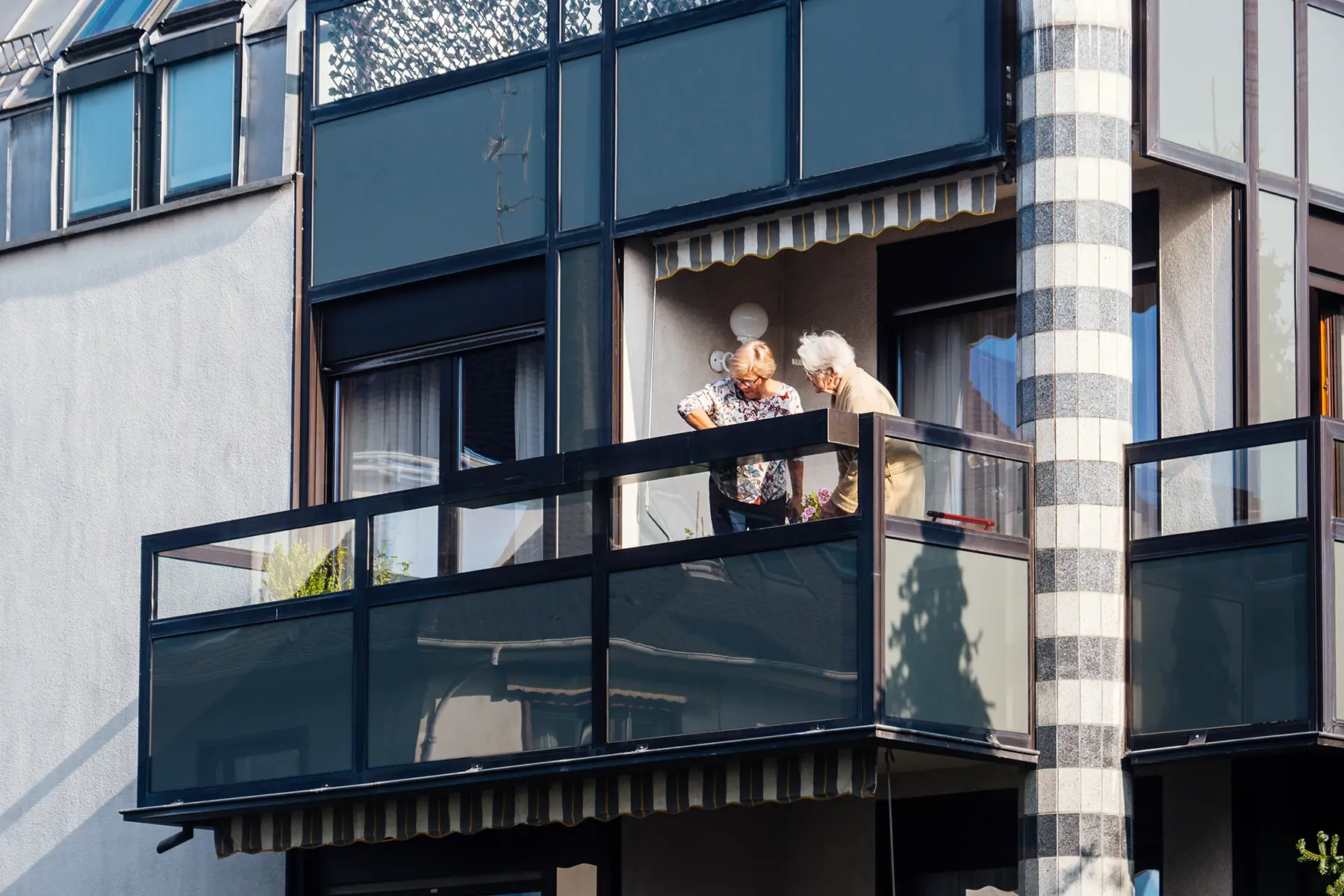 Two elderly women on a balcony in Paris