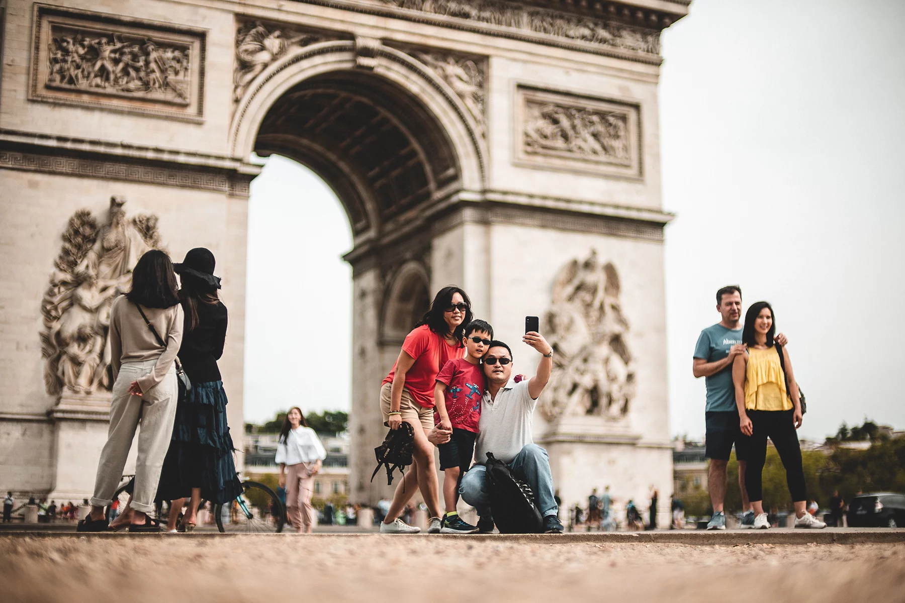Family of new immigrants taking a selfie at the Arc de Triomph