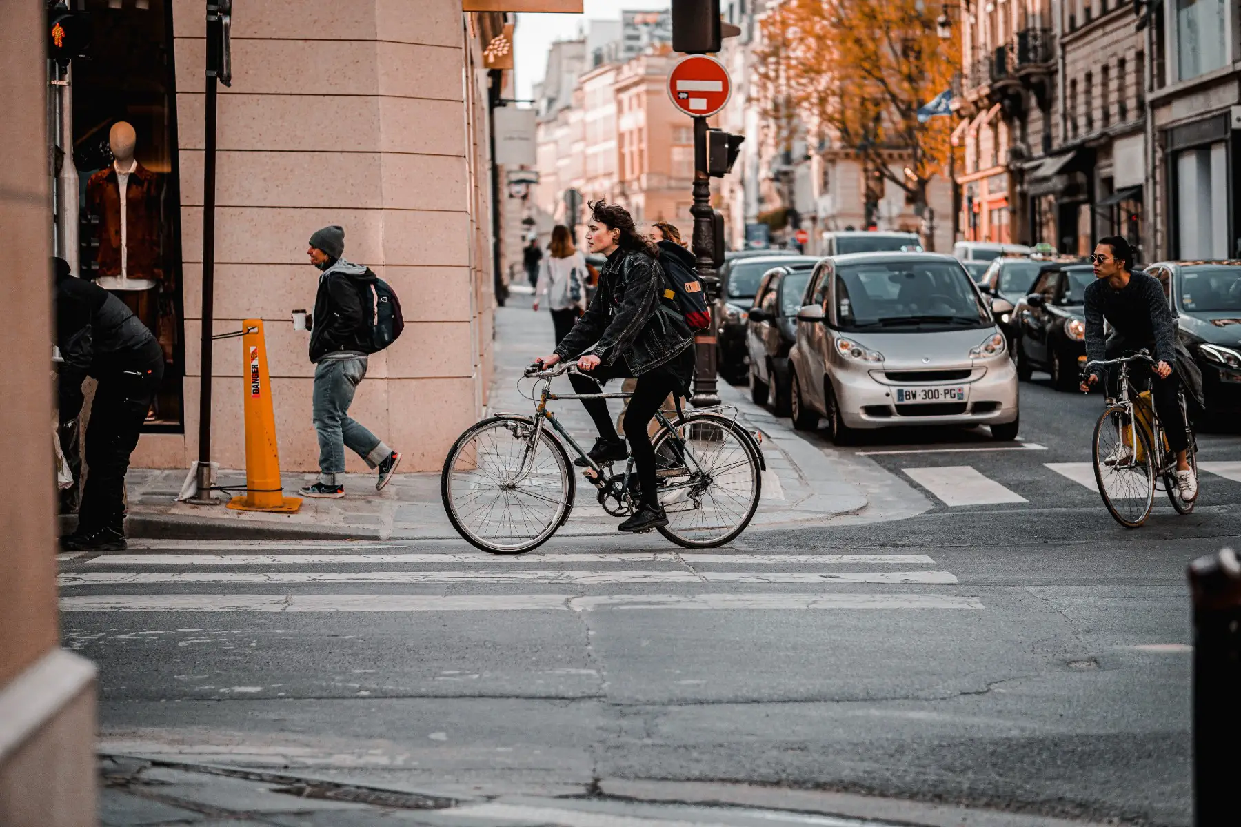 Cyclists moving between cars on a Parisian street
