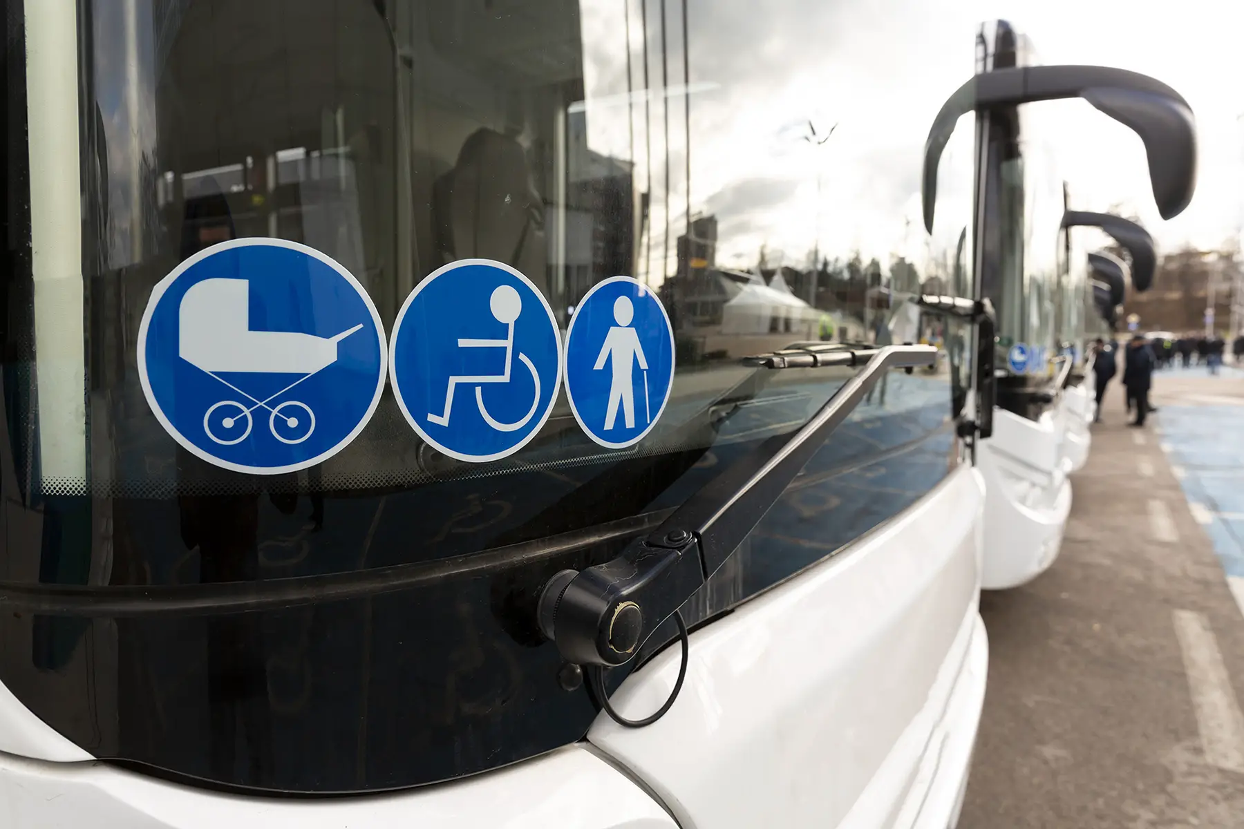 Stickers in the window of a French bus indicating the accessibility features