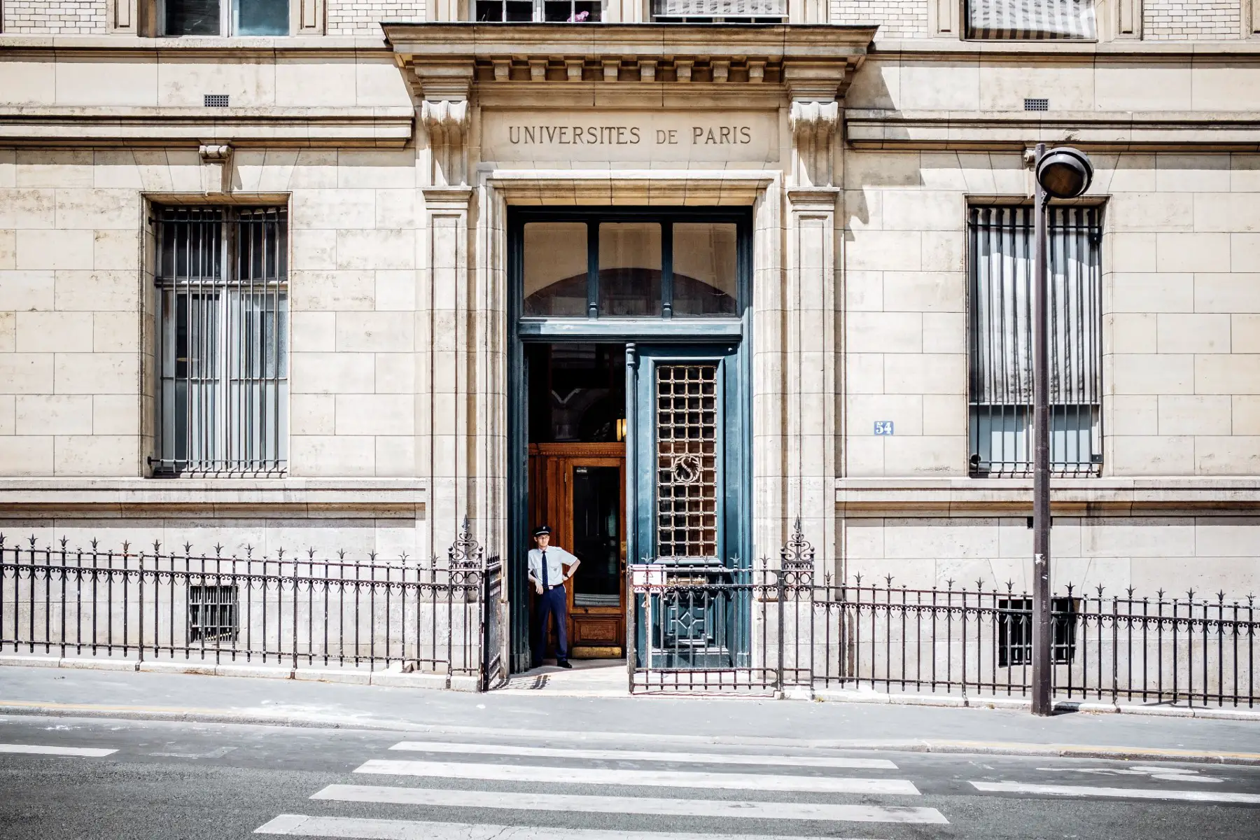Guard standing at the door of the University of Paris, also known as La Sorbonne.