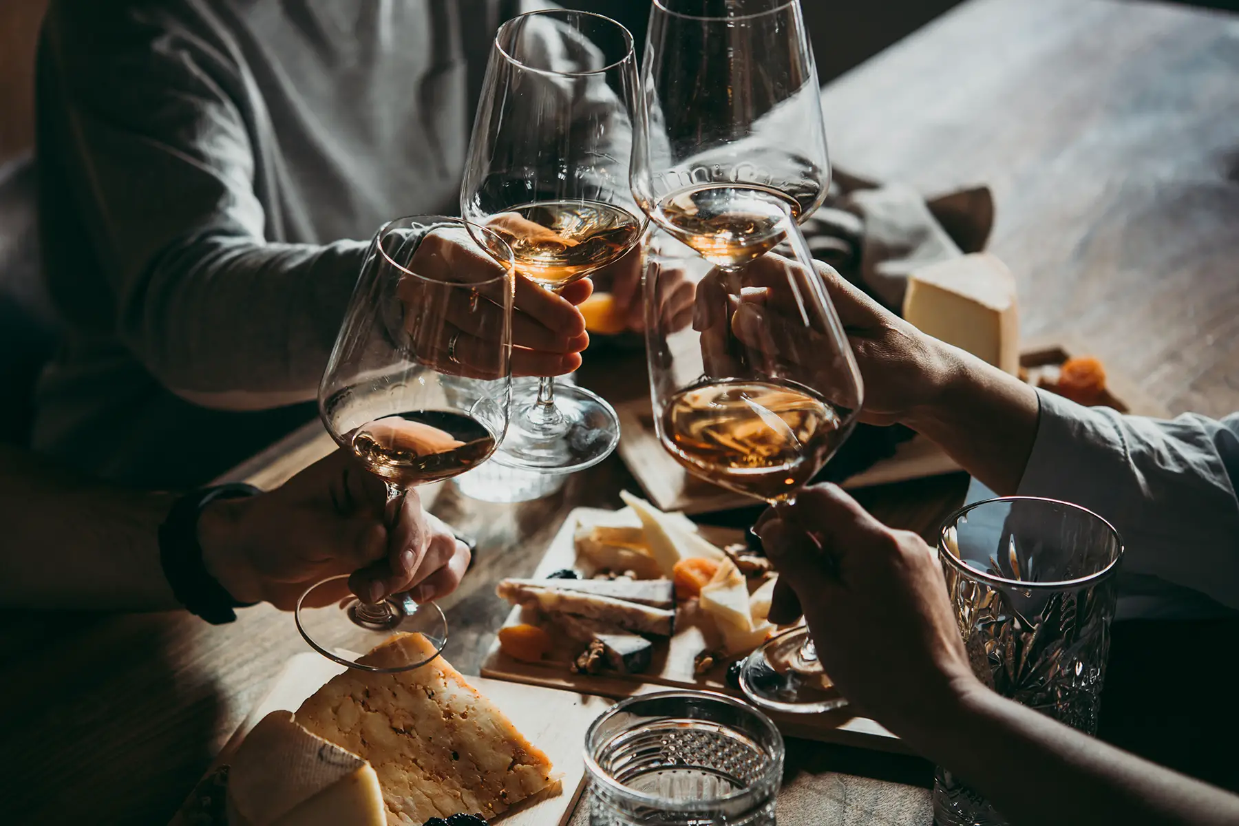 Friends enjoying wine and cheese together