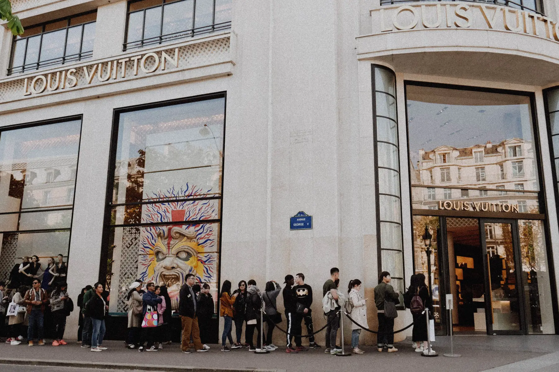 Queue of shoppers outside of a Louis Vuitton shop in Paris, France