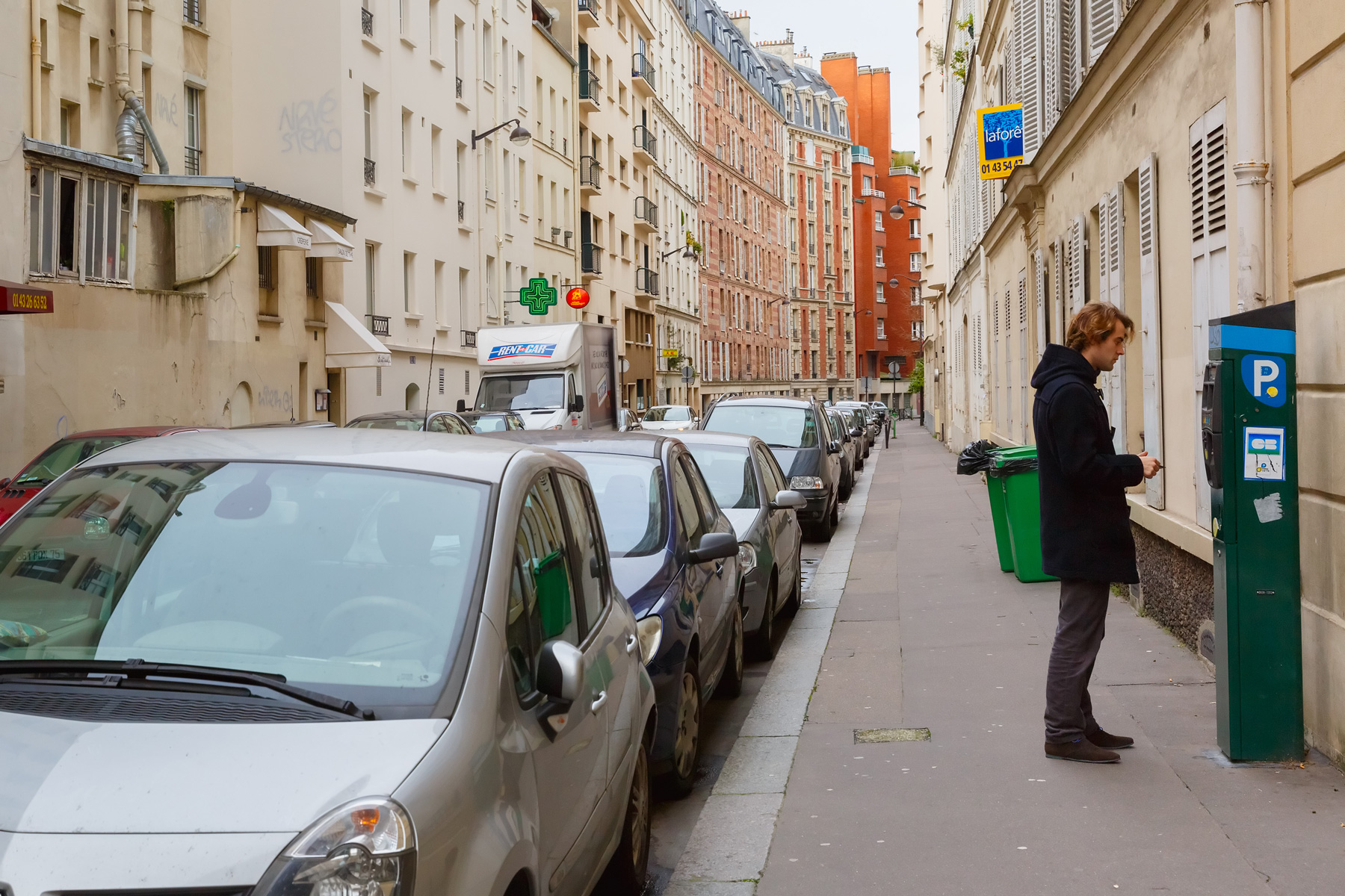 Man paying to park on street in Paris