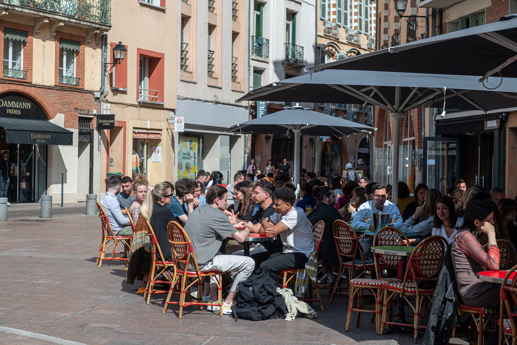 Lots of young people sitting at an outdoor café in Toulouse