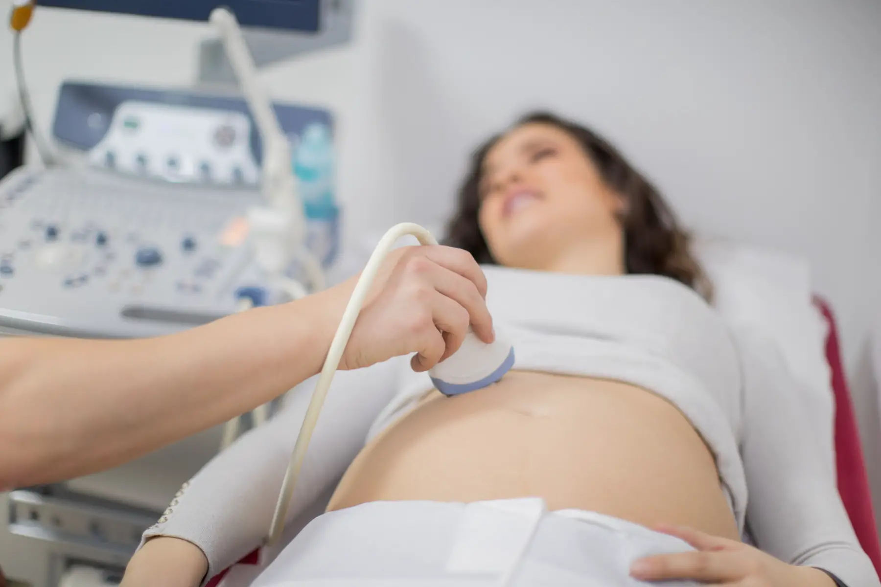 a doctor performing an ultrasound on a pregnant woman
