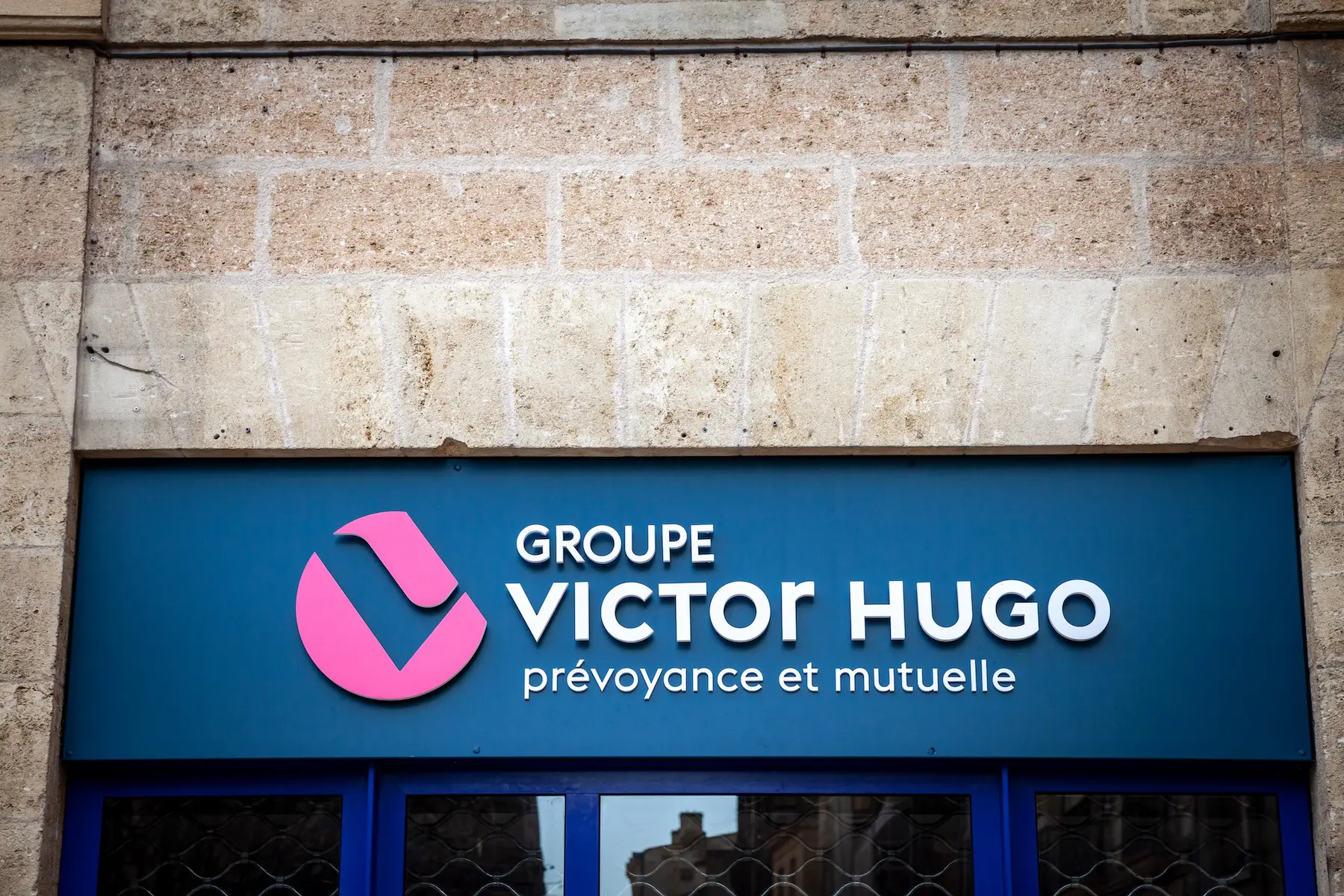 Picture of a sign with the logo of Mutuelle Groupe Victor Hugo on their main office for Bordeaux, France