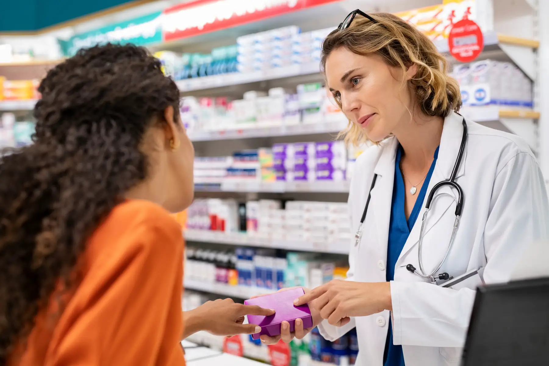 Pharmacist helping woman with contraceptives