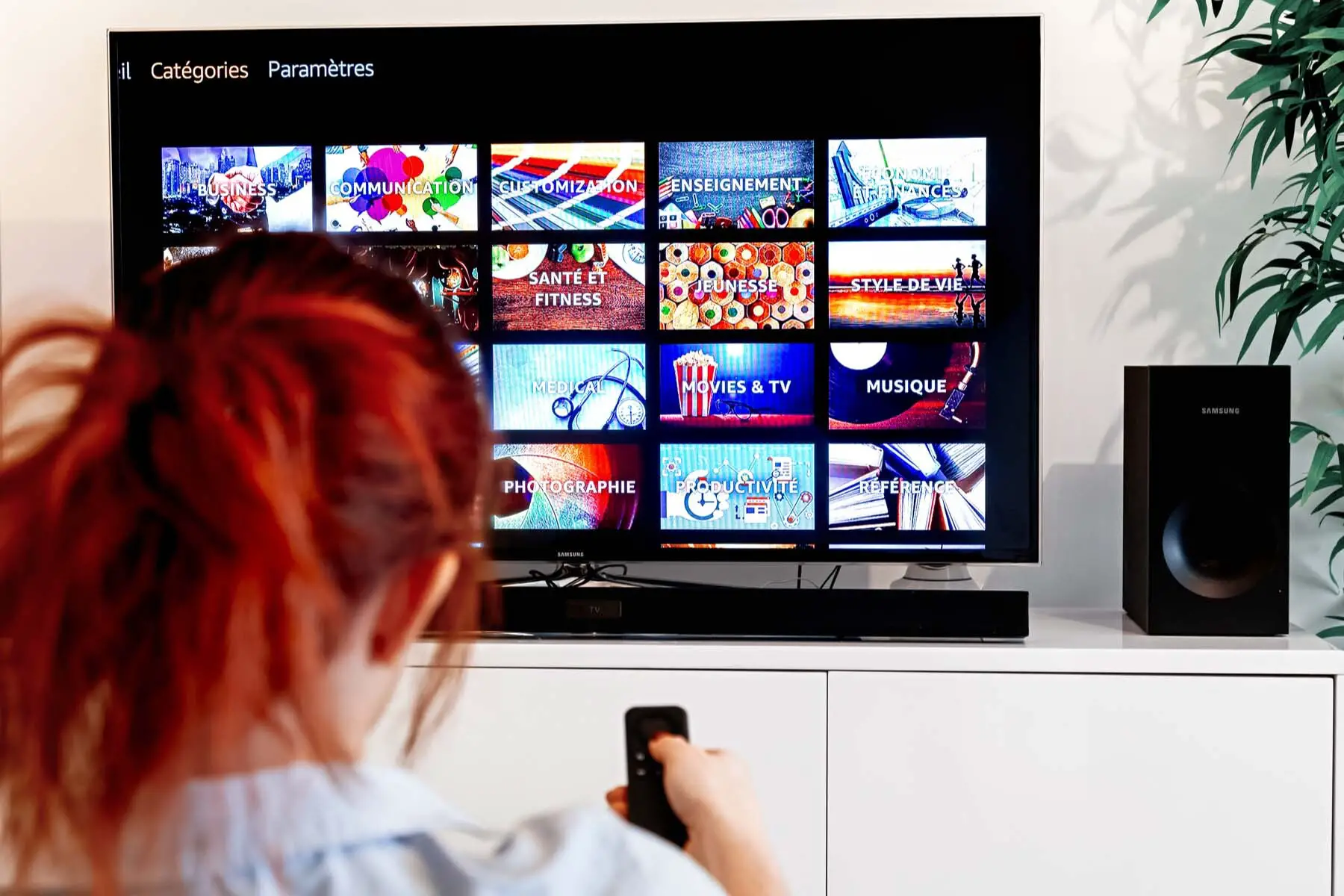 Woman scrolling through French TV channels