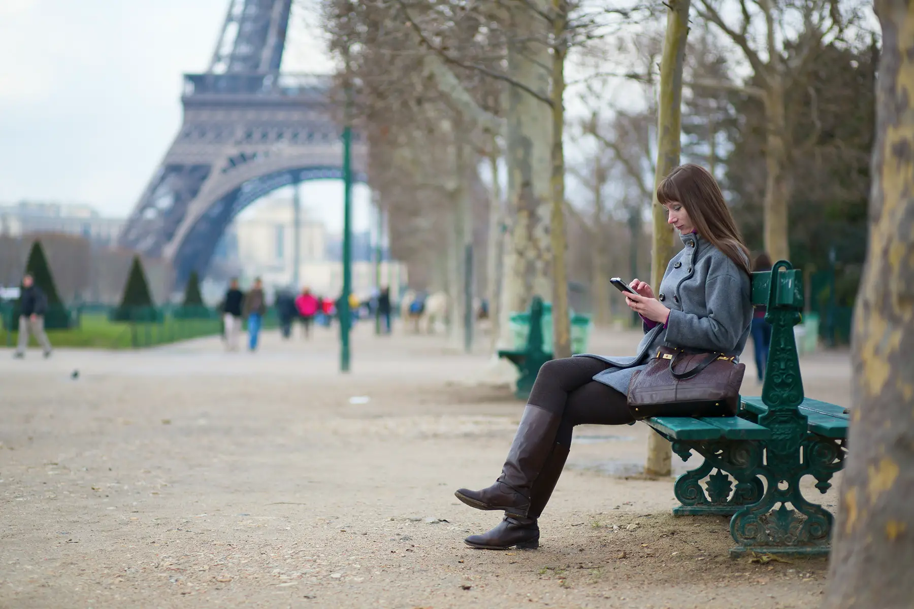 Woman using her mobile phone in Paris