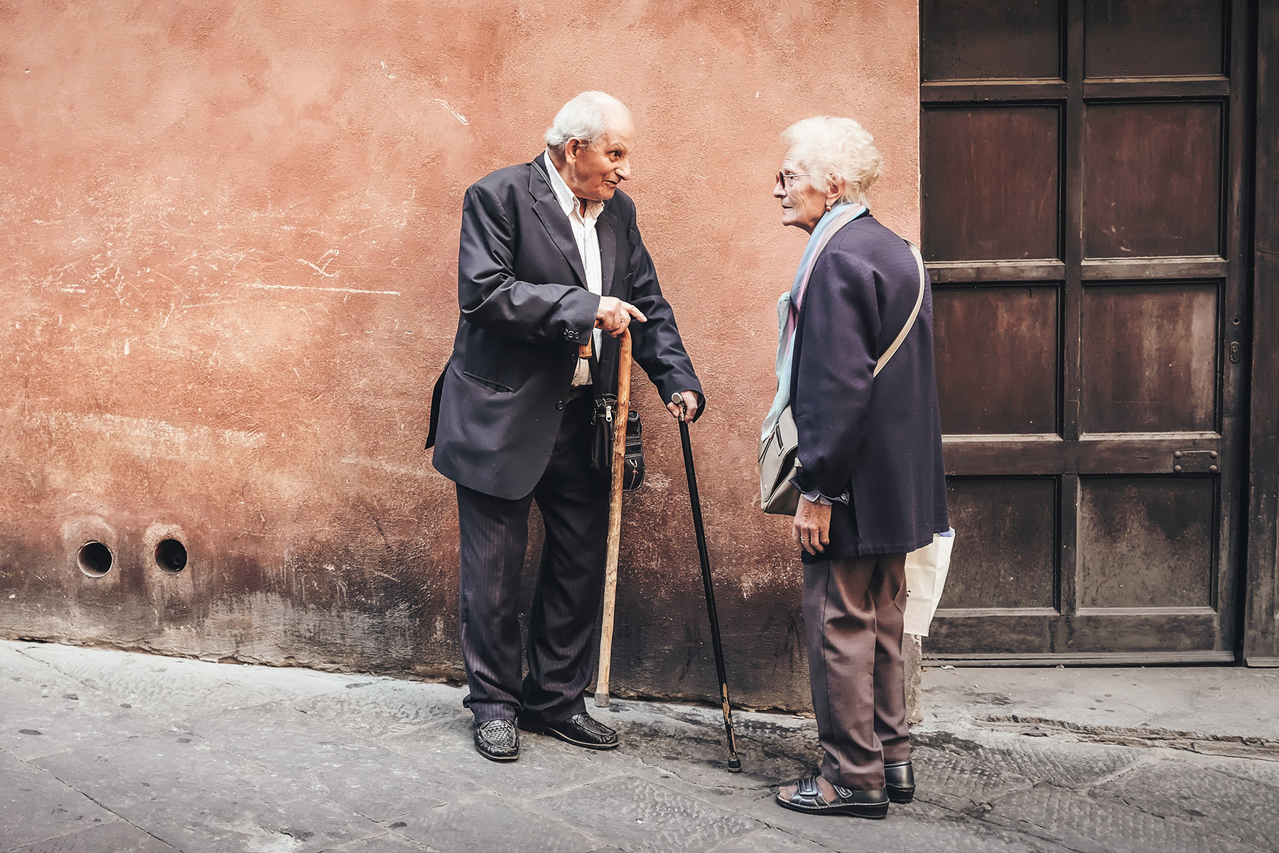Two seniors talking on the street