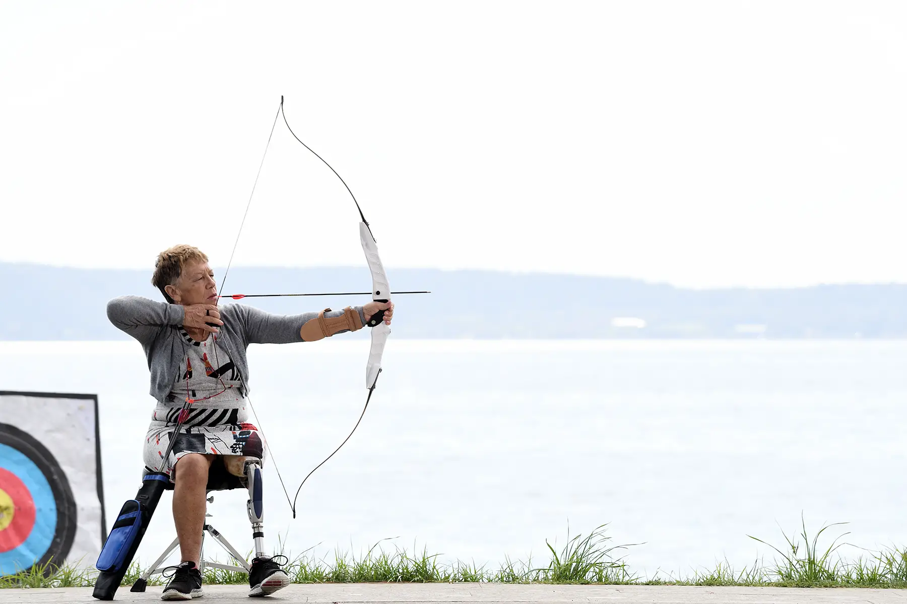 A person with a prosthetic leg doing archery