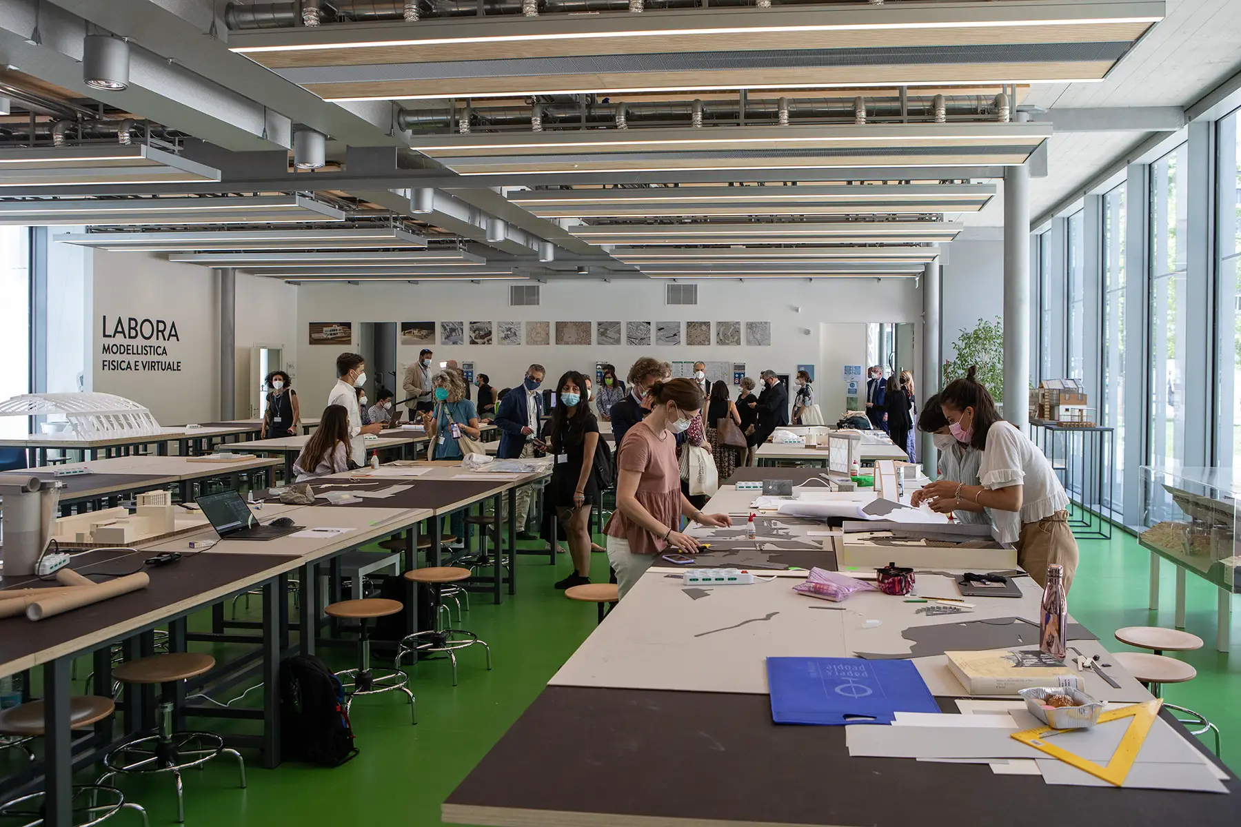 Architecture students working in a studio at Politecnico di Milano, all wearing masks