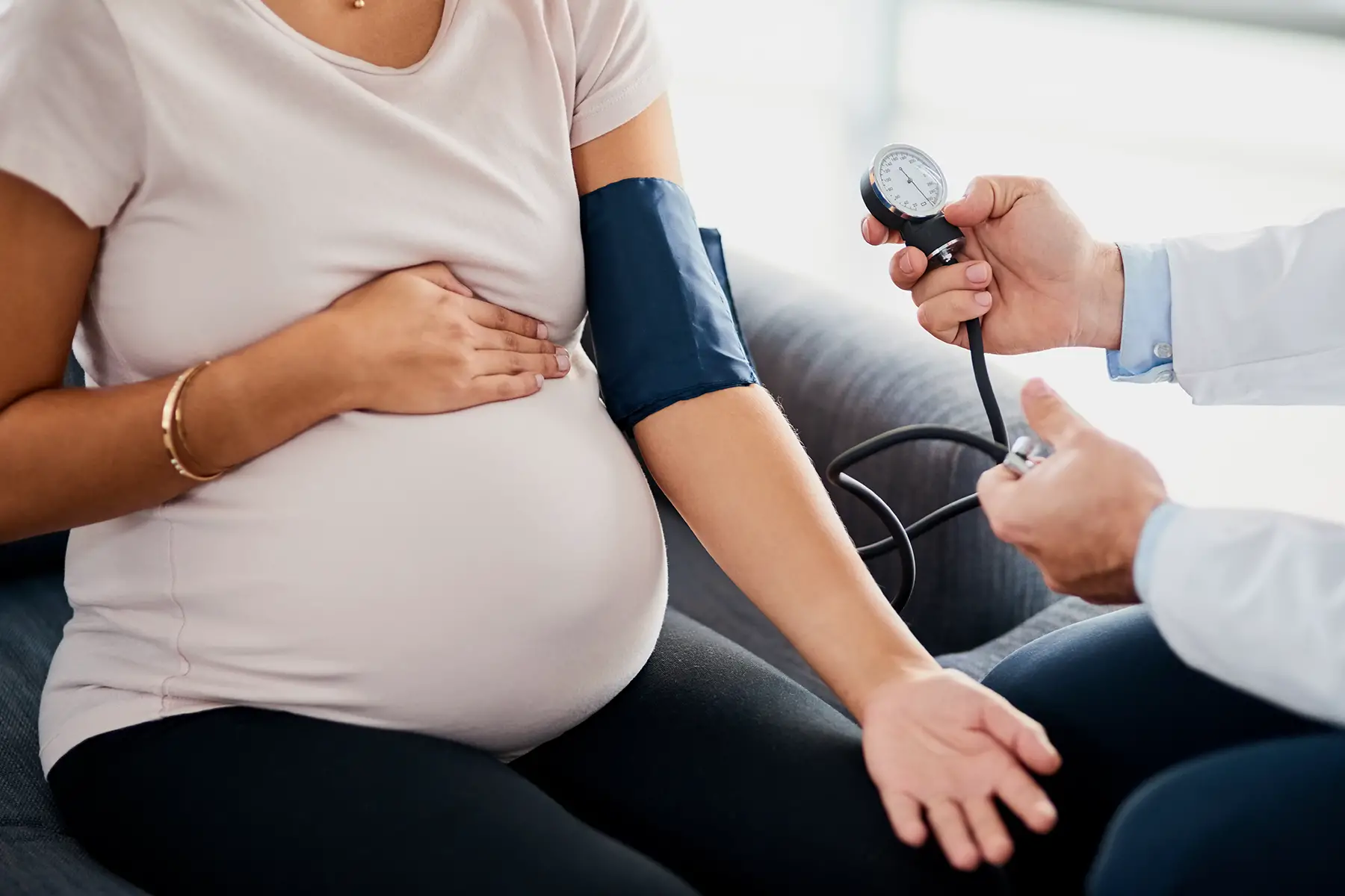 A pregnant woman getting her blood pressure measured